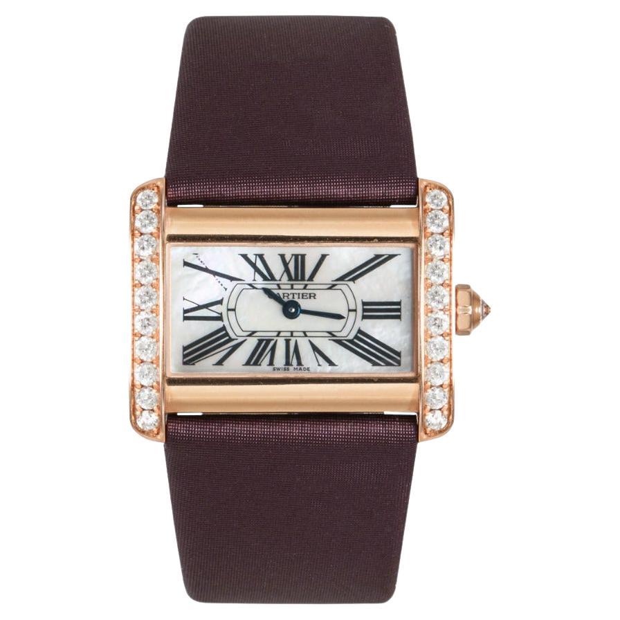 A Cartier Tank Divan for ladies crafted in rose gold. Featuring a stunning mother of pearl dial with roman numerals, blued-steel sword shaped hands and a secret Cartier signature at X. The watch has a fixed rose gold bezel set with 20 round