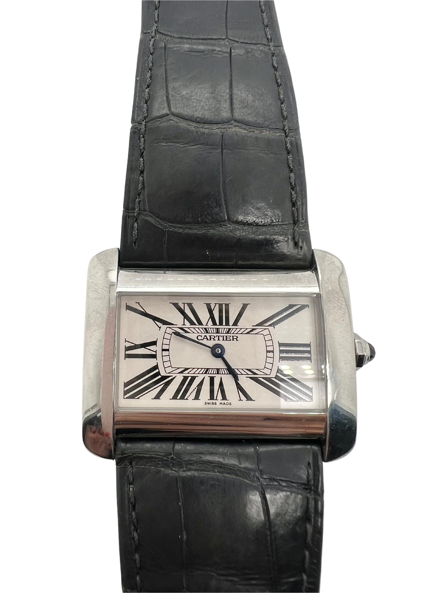 Cartier Tank Divan Stainless Steel Watch

Details:
Case size: 38mm x 24mm 
Case Material: Stainless steel
Movement: Quartz
Dial: White with Roman numerals
Crystal: Sapphire
Strap material: leather with stainless steel buckle marked 