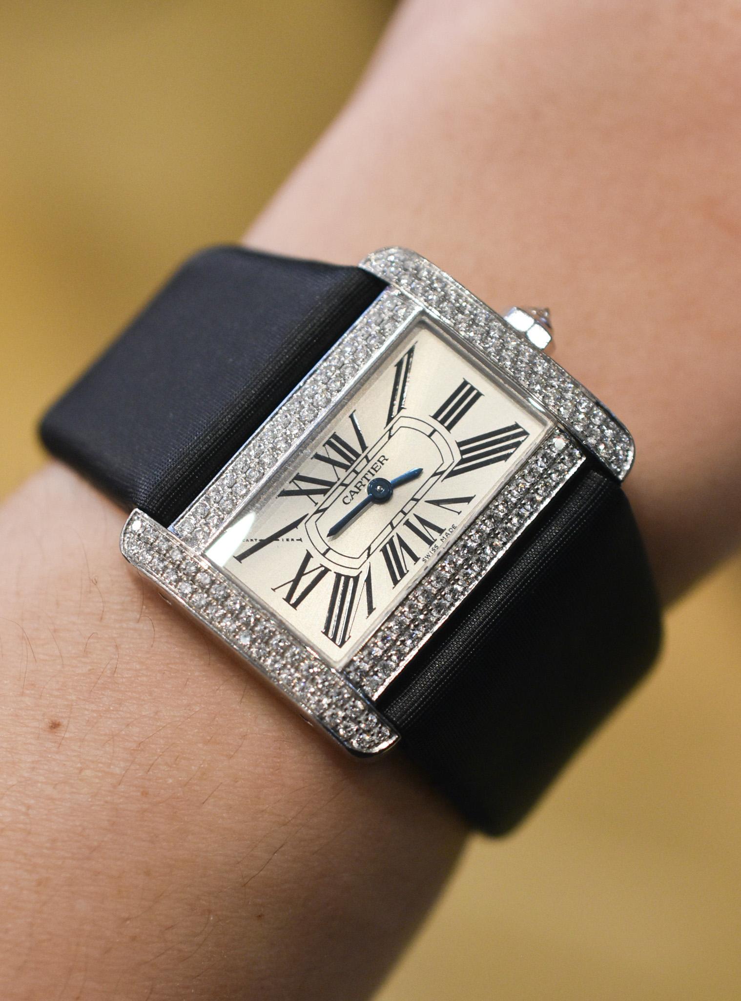 An elegant Cartier Tank Divan Dress Watch Ref. 2613 in 18k White gold with Diamond-set Dial and Roman Numerals. The case measures 31 x 25mm with Original Cartier Leather Strap and Buckle.
Made in France, circa 1990. 