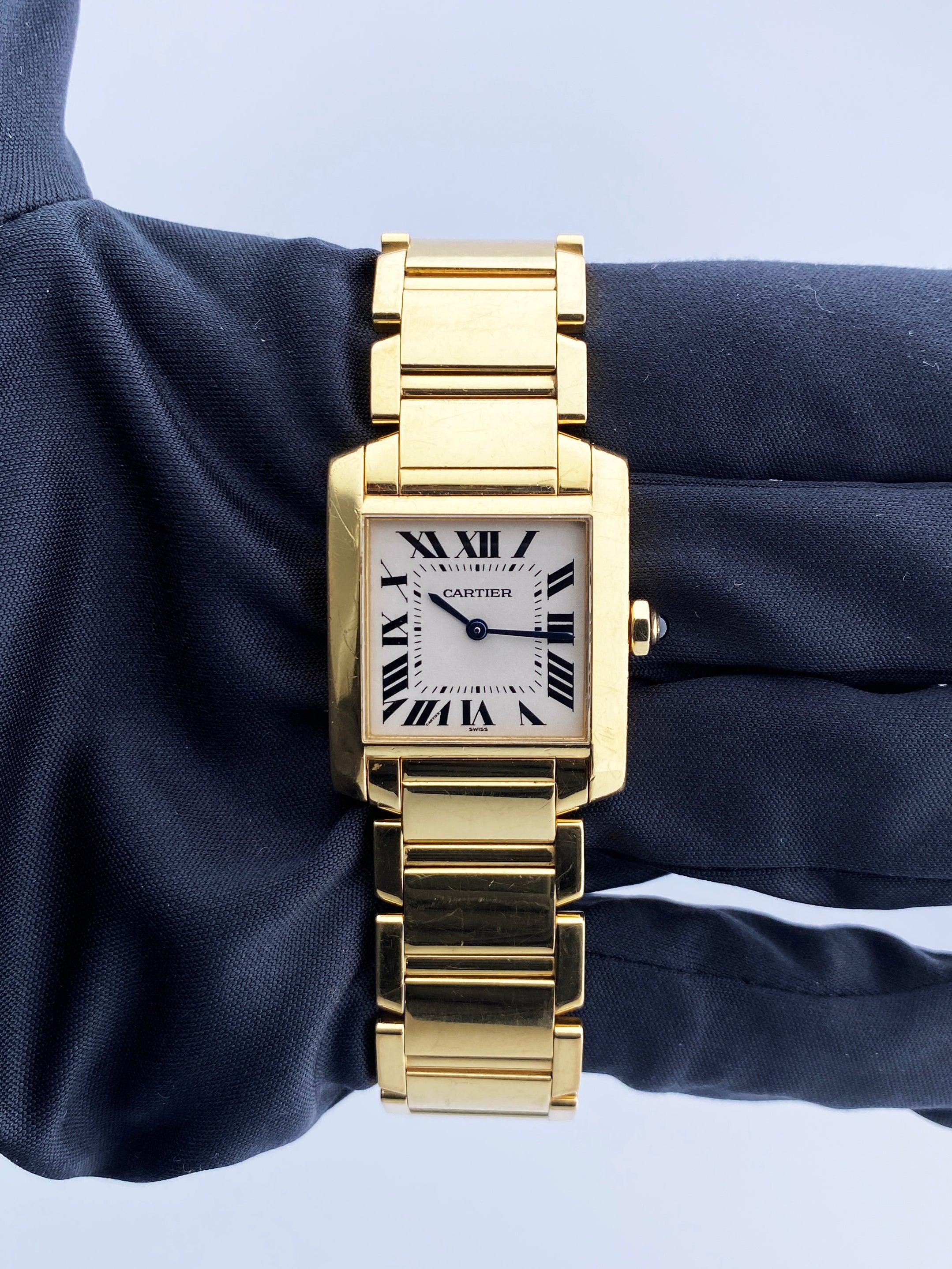 Cartier Tank Francaise 1821 Ladies Watch. 25mm 18k yellow gold case with 18K yellow gold bezel. Off-White dial with blue steel hands and Roman numeral hour markers. Minute markers on the inner dial. 18k yellow gold bracelet with hidden butterfly