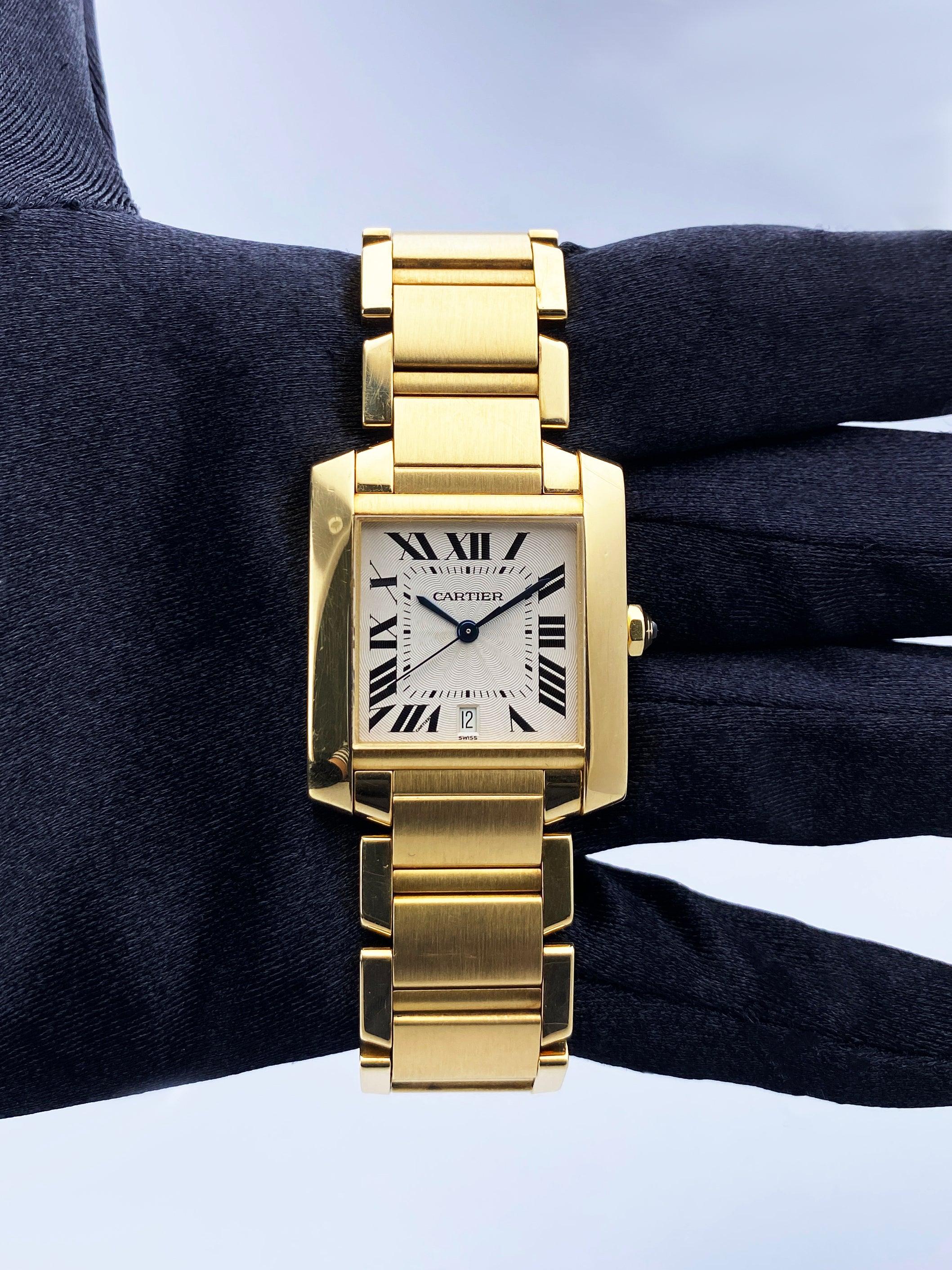 Cartier Tank Francaise 1840 Mens Watch. 29mm 18K yellow gold case with smooth bezel. Off-White dial with blue steel hands and black Roman numeral hour markers. Date display at the 6 o'clock position. Minute markers on the inner dial. 18K yellow gold