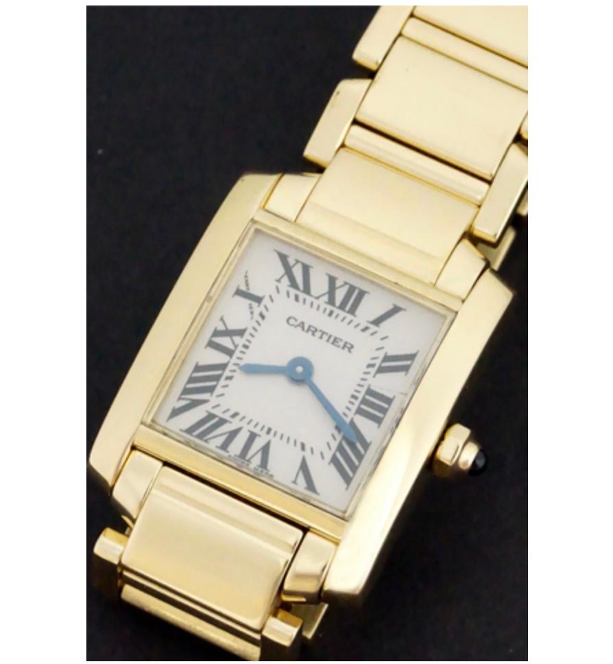 Gorgeous 18k gold Cartier ladies Tank Française Model 50002N2 case size 20x25 millimeters. The watch features a silver dial with black Roman numerals and blued hour and minute hands all cased in 18k gold. Powered by a quartz movement, this watch