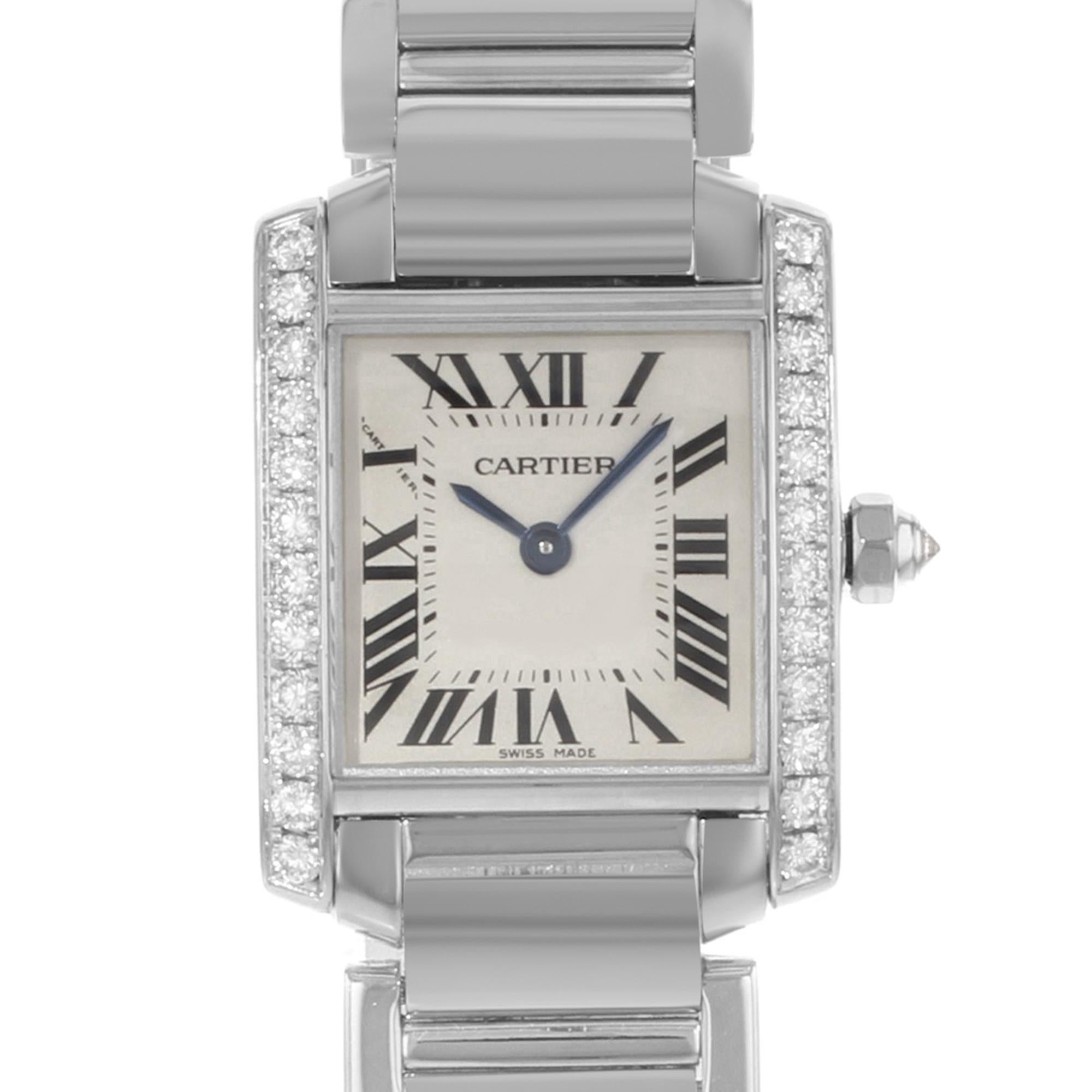This  never been worn  Cartier Tank  WE1002S3  is a beautiful Ladie's timepiece that is powered by quartz (battery) movement which is cased in a white gold case. It has a square shape face, no features dial and has hand roman numerals style markers.