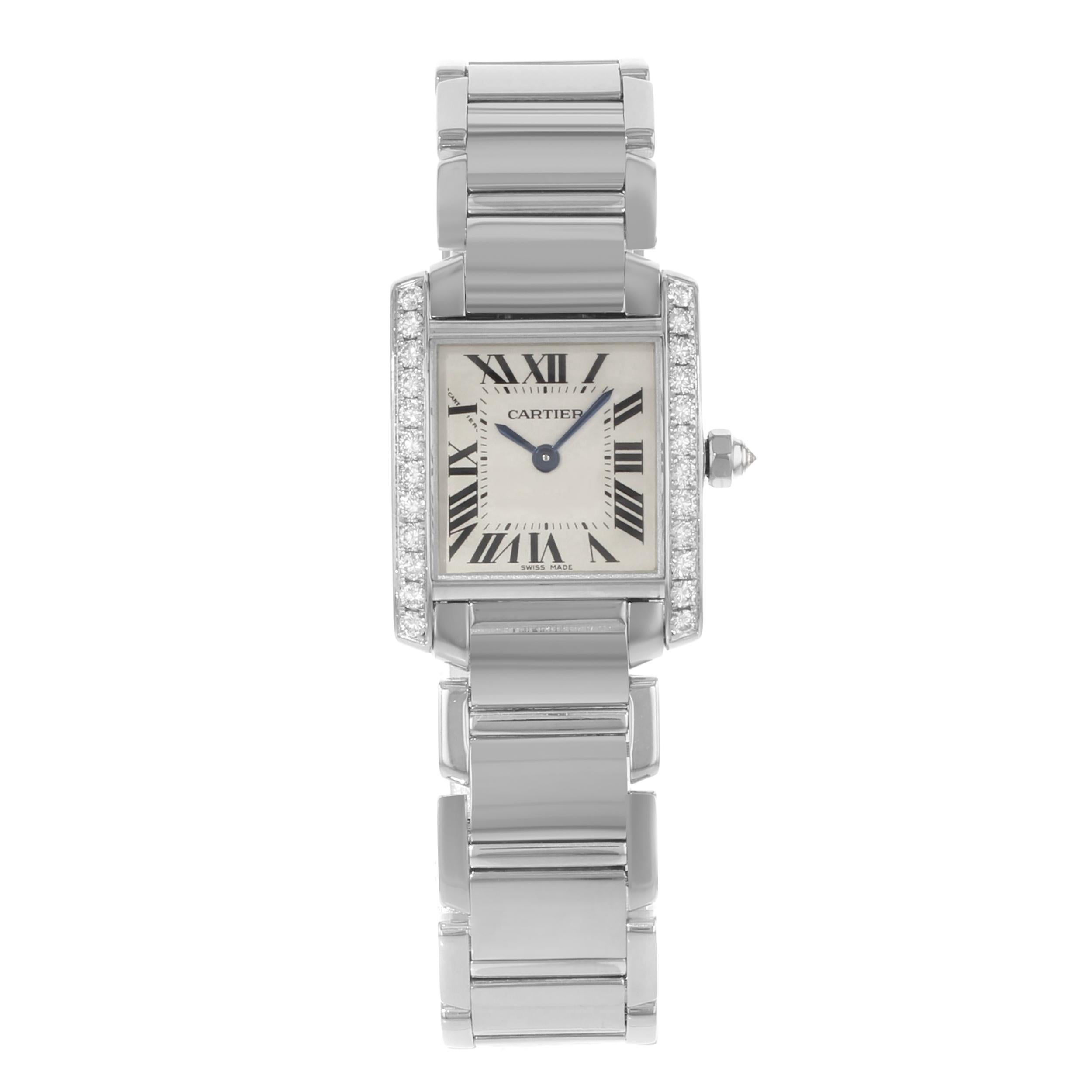 This  Cartier Tank  WE1002S3  is a beautiful Ladies timepiece that is powered by a quartz movement which is cased in a white gold case. It has a square shape face, no features dial, and has hand roman numerals style markers. It is completed with a