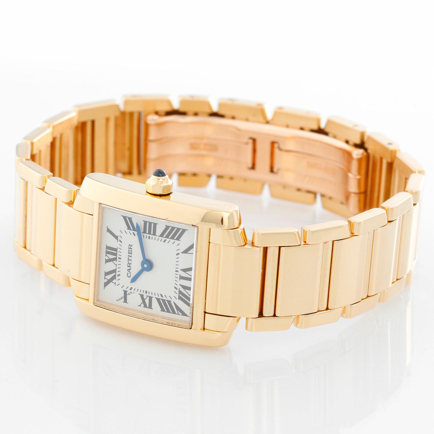 Cartier Tank Francaise 18k Yellow Gold Ladies Watch - Quartz. 18k yellow gold  case (20mm x 25mm). Ivory colored dial with black Roman numerals. 18k yellow gold Cartier Tank Francaise bracelet. Pre-owned with custom box. 