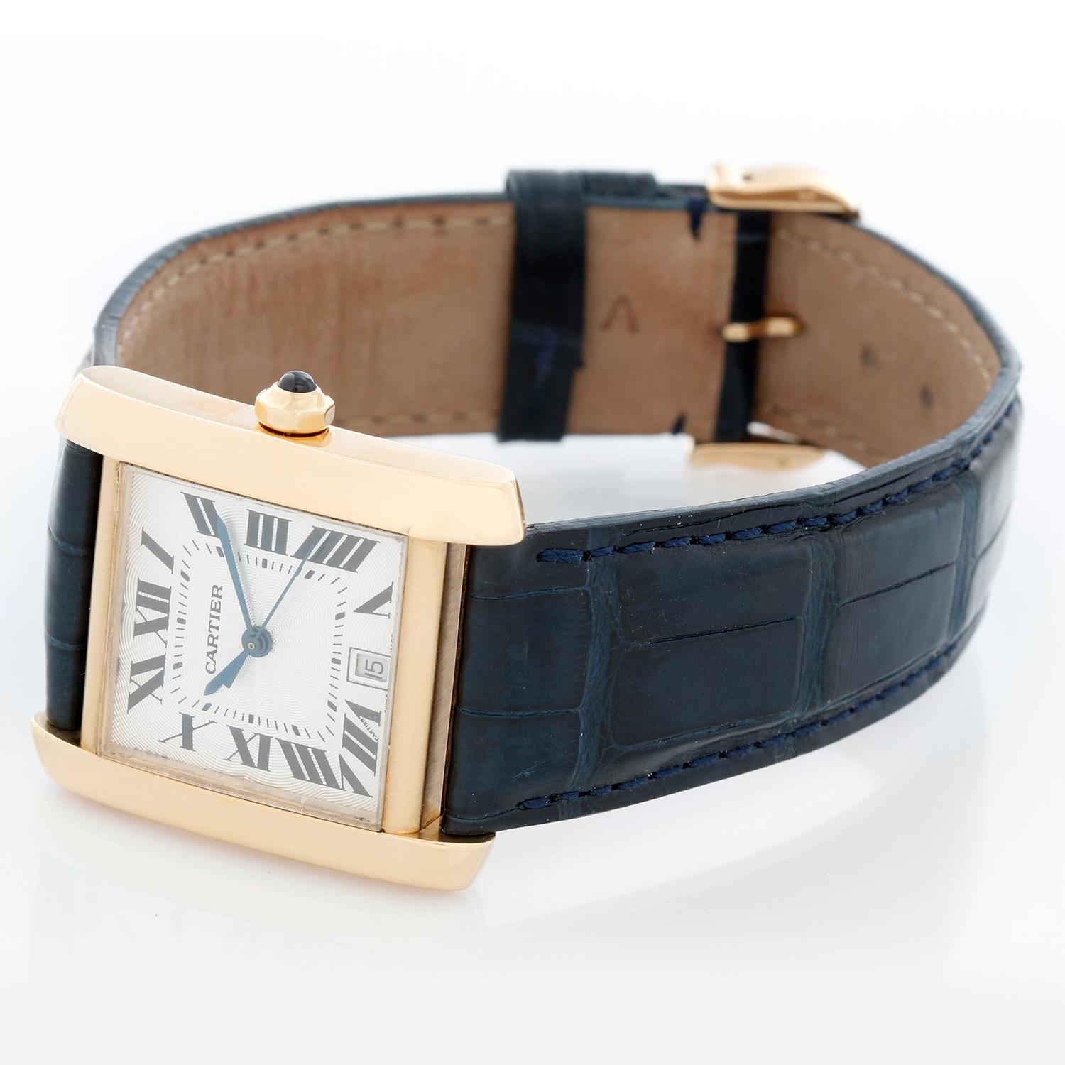 Cartier Tank Francaise 18k Yellow Gold Men's Watch W5000156 - Automatic winding; date at 6 o'clock. 18k yellow gold case (28mm x 31mm). Silver guilloche dial with black Roman numerals. Blue strap band with 18k yellow gold Cartier buckle. Pre-owned