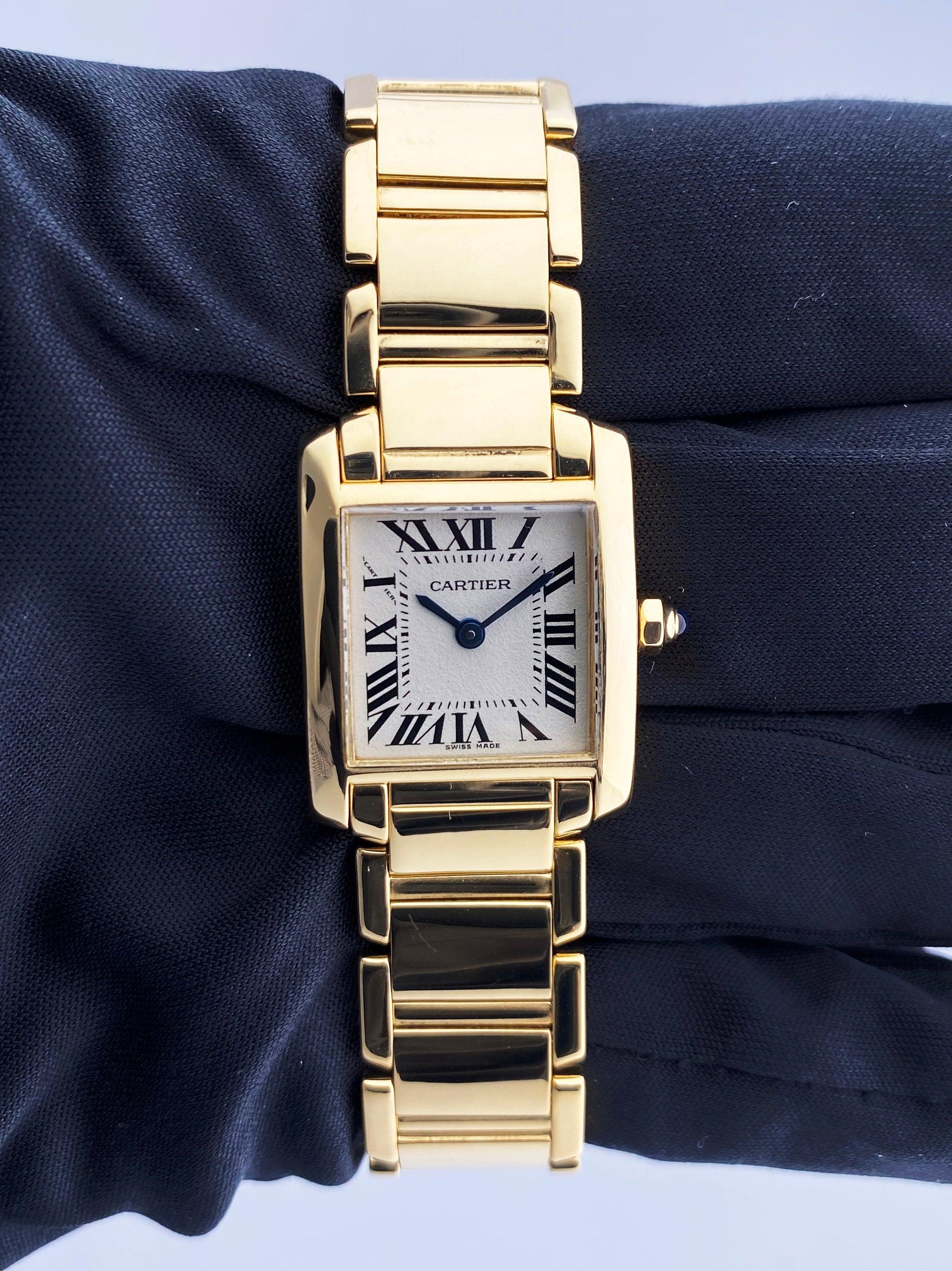 Cartier Tank Francaise 2385 ladies watch. 20mm 18k yellow gold case with 18K yellow gold bezel. Off-White dial with Blue steel hands and Roman numeral hour markers. Minute markers on the inner dial. 18K yellow gold bracelet with Hidden Butterfly.