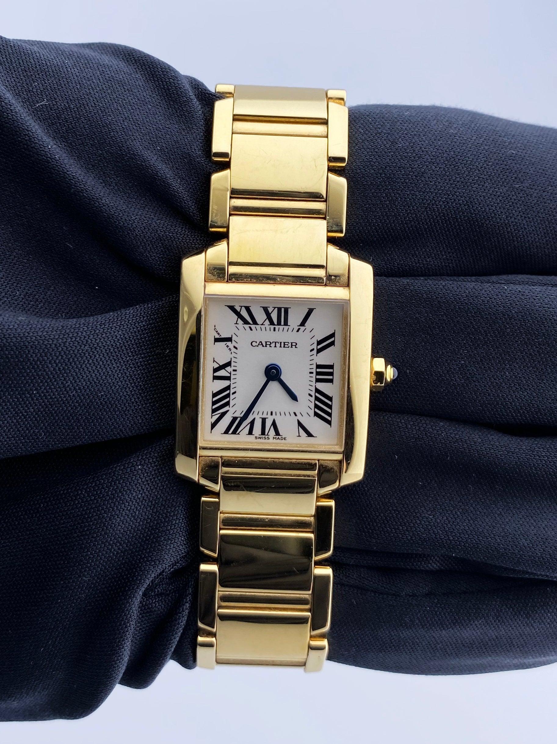 Cartier Tank Francaise 2385 Ladies Watch. 20mm 18k yellow gold case with 18K yellow gold bezel. Off-White dial with Blue steel hands and Roman numeral hour markers. Minute markers on the inner dial. 18K yellow gold bracelet with hidden butterfly.