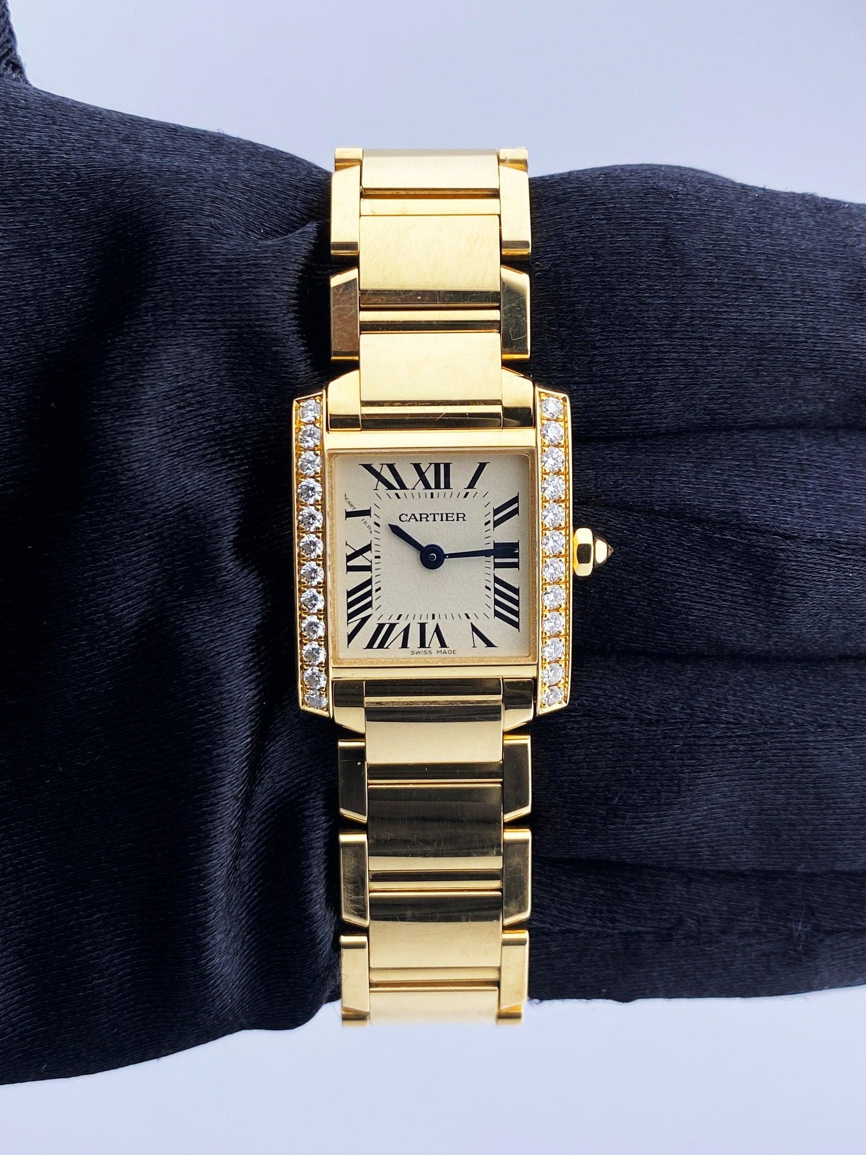 Cartier Tank Francaise 4205/WJTA0024 Ladies Watch. 20mm 18K yellow gold case. 18K yellow gold bezel with original factory diamond set. Off-White dial with blue steel hands and black Roman numeral hour markers. Minute markers on the inner dial. 18K