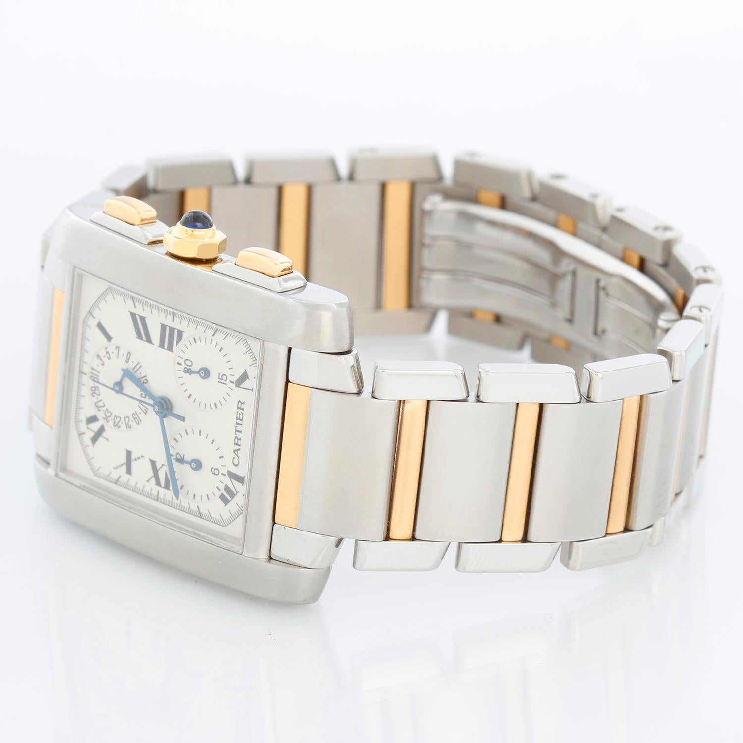 Cartier Tank Francaise Chronograph Men's Steel & Gold Watch  - Quartz. Stainless steel case; crown set with blue sapphire cabochon (28mm x 37mm). Ivory colored dial with black Roman numerals. Stainless steel & 18k gold Cartier bracelet. Pre-owned