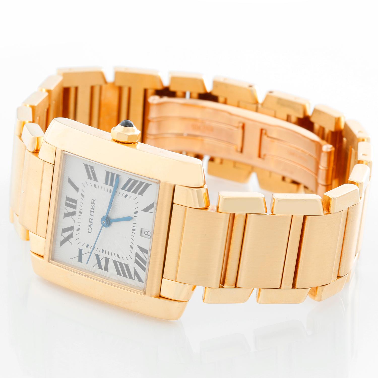 Cartier Tank Francaise Men's Automatic Watch - Automatic winding. 18k yellow gold case (28mm x 35mm). Ivory colored dial with black Roman numerals; date at 6 o'clock. 18k yellow gold Cartier bracelet with deployant clasp. Pre-owned with Cartier box