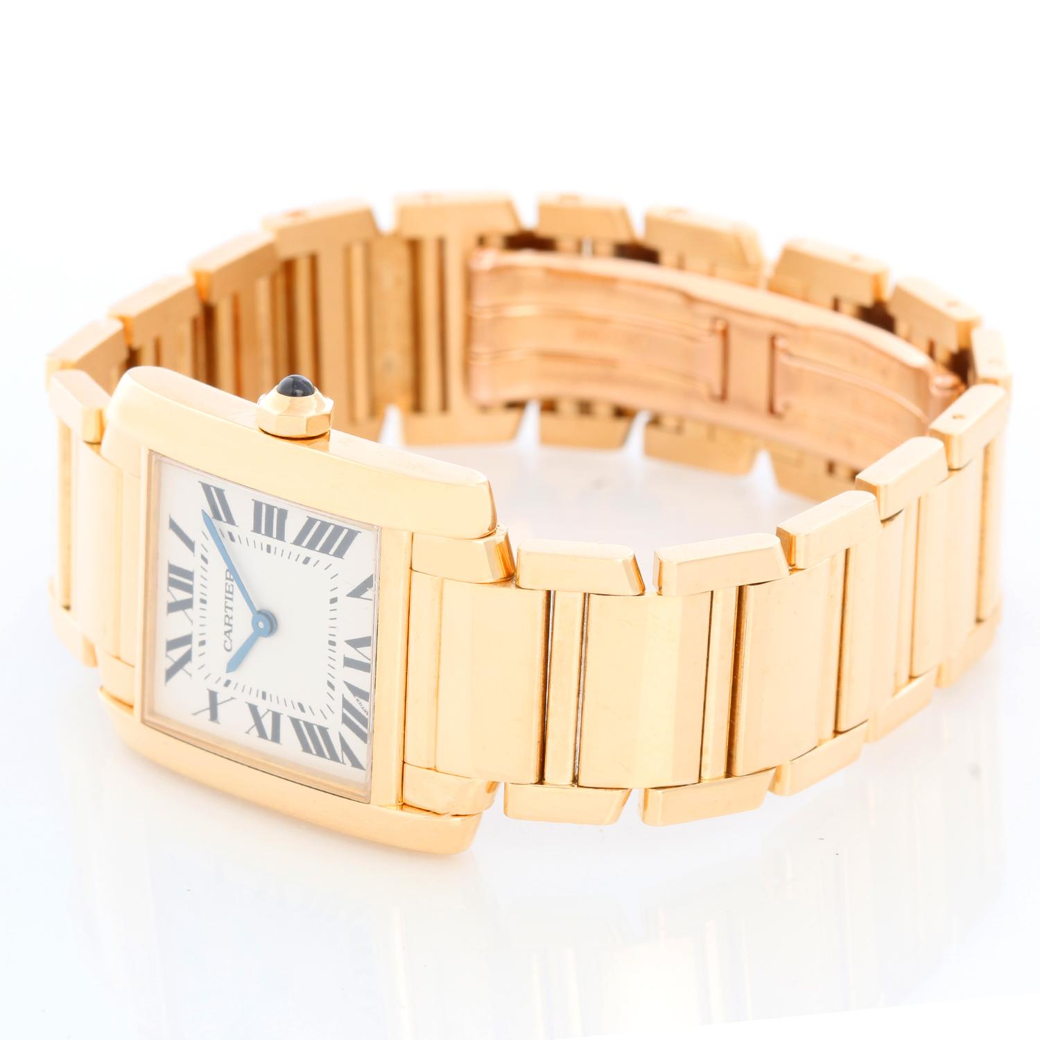 Cartier Tank Francaise Midsize 18k Yellow Gold Watch W50003N2 1821 - Quartz. 18k yellow gold  case; blue sapphire cabochon crown (25mm x 30mm). Ivory colored dial with black Roman numerals. Cartier 18k yellow gold bracelet. Pre-owned with Cartier