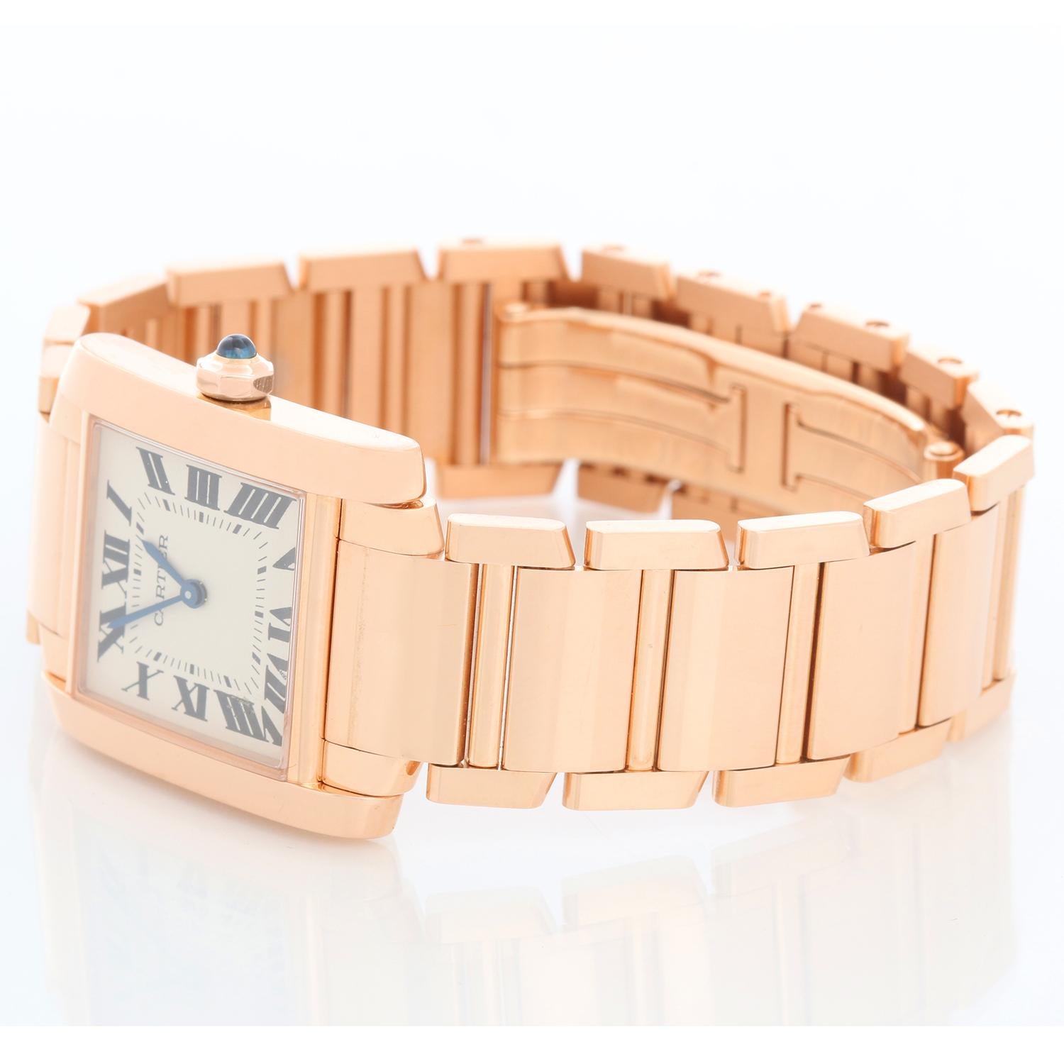 Cartier Tank Francaise Midsize 18k Rose Gold Watch WGTA0030 - Quartz. 18k rose gold  case; blue sapphire cabochon crown (25mm x 30mm).  Ivory colored dial with black Roman numerals; date at 3 o'clock. Cartier 18k rose gold bracelet; will fit a 6 3/4