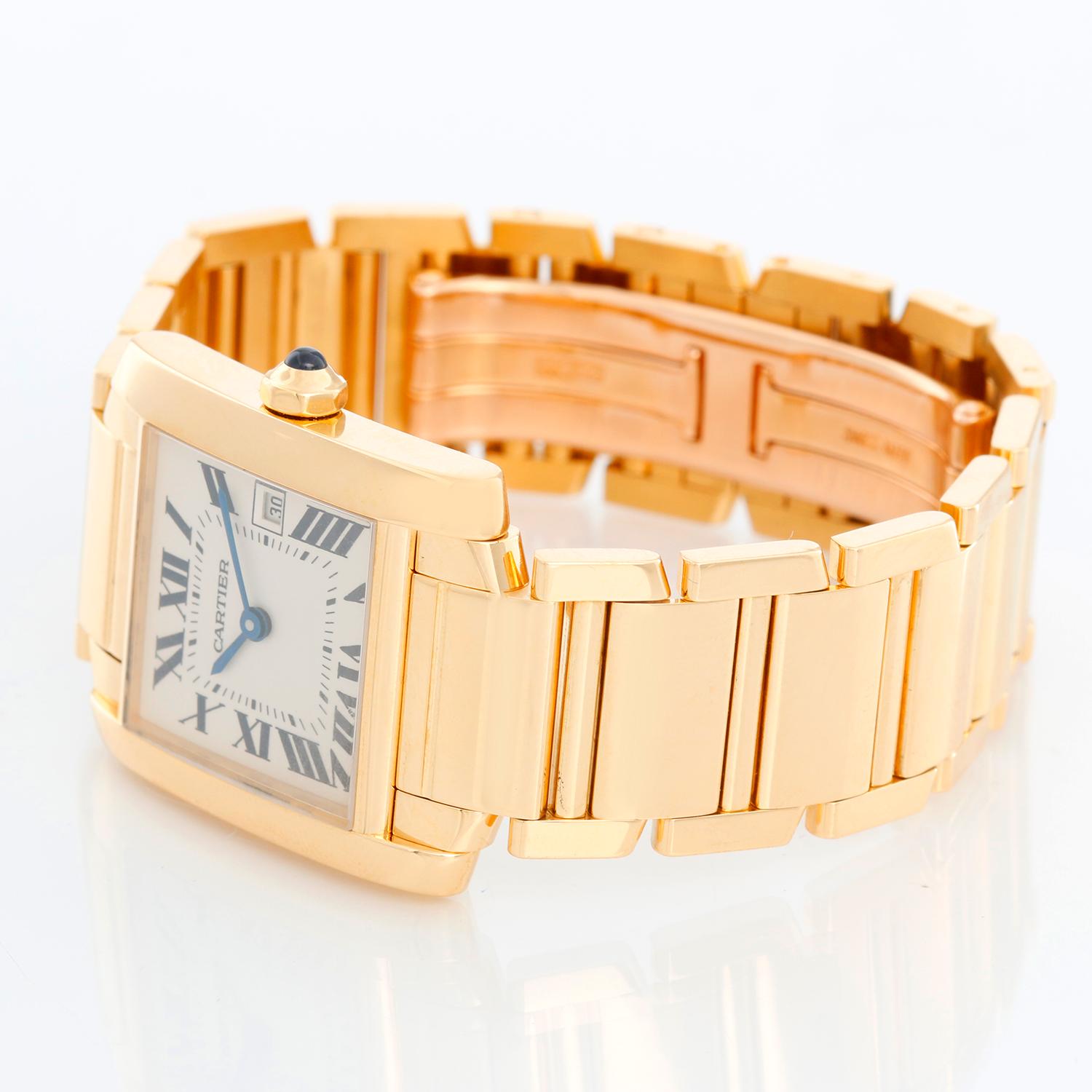 Cartier Tank Francaise Midsize 18k Yellow Gold Men's/Ladies Watch W50014N2 - Quartz. 18k yellow gold  case; blue sapphire cabochon crown (25mm x 30mm).  Ivory colored dial with black Roman numerals; date at 3 o'clock. Cartier 18k yellow gold