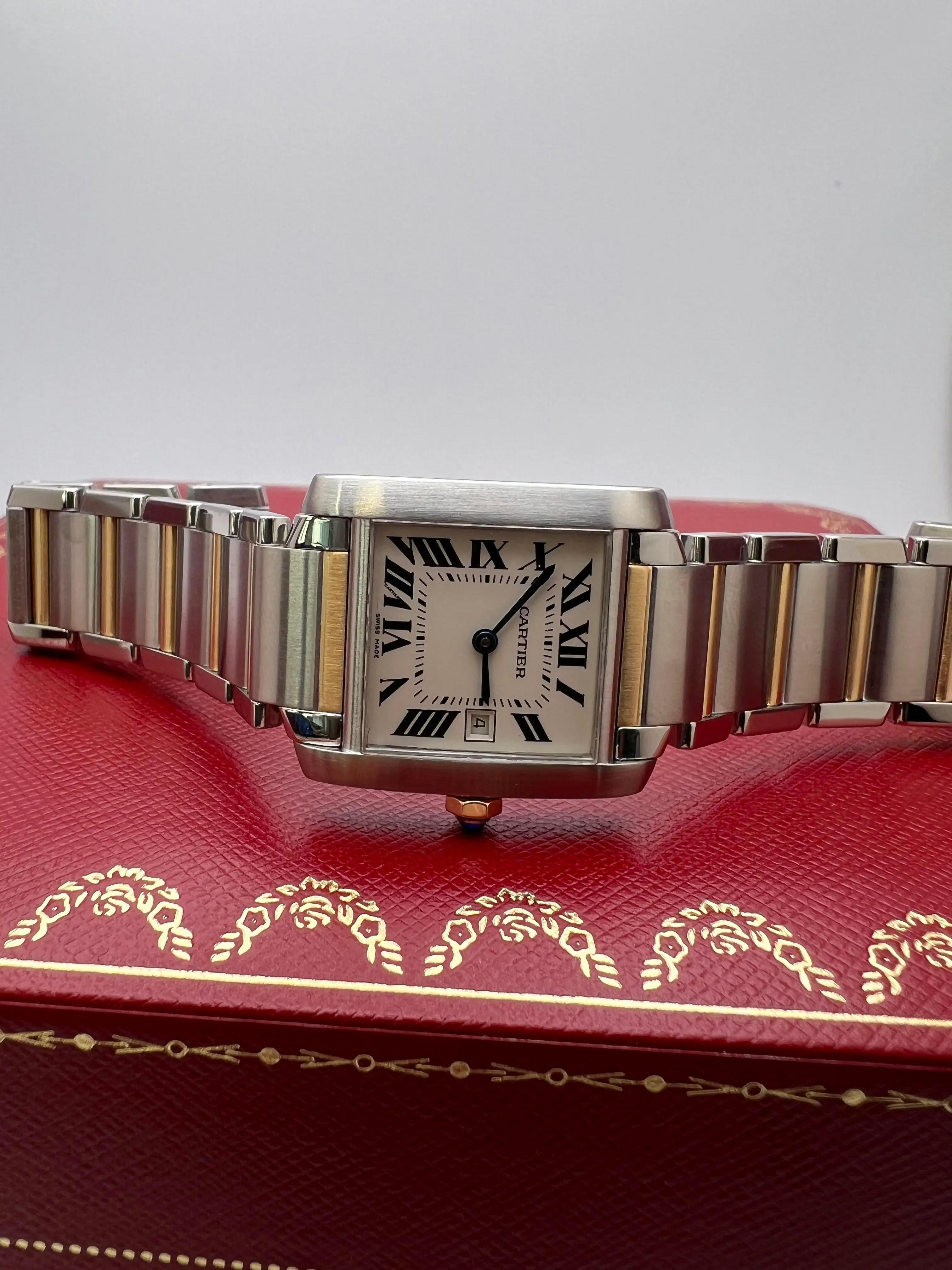 The Cartier Tank Française Medium (ref. W51012Q4) is a classic two-tone execution of Cartier’s most recognizable design. The stainless steel case, accented with 18K yellow gold, measures 25mm x 30mm, giving it a versatile mid-size presence that