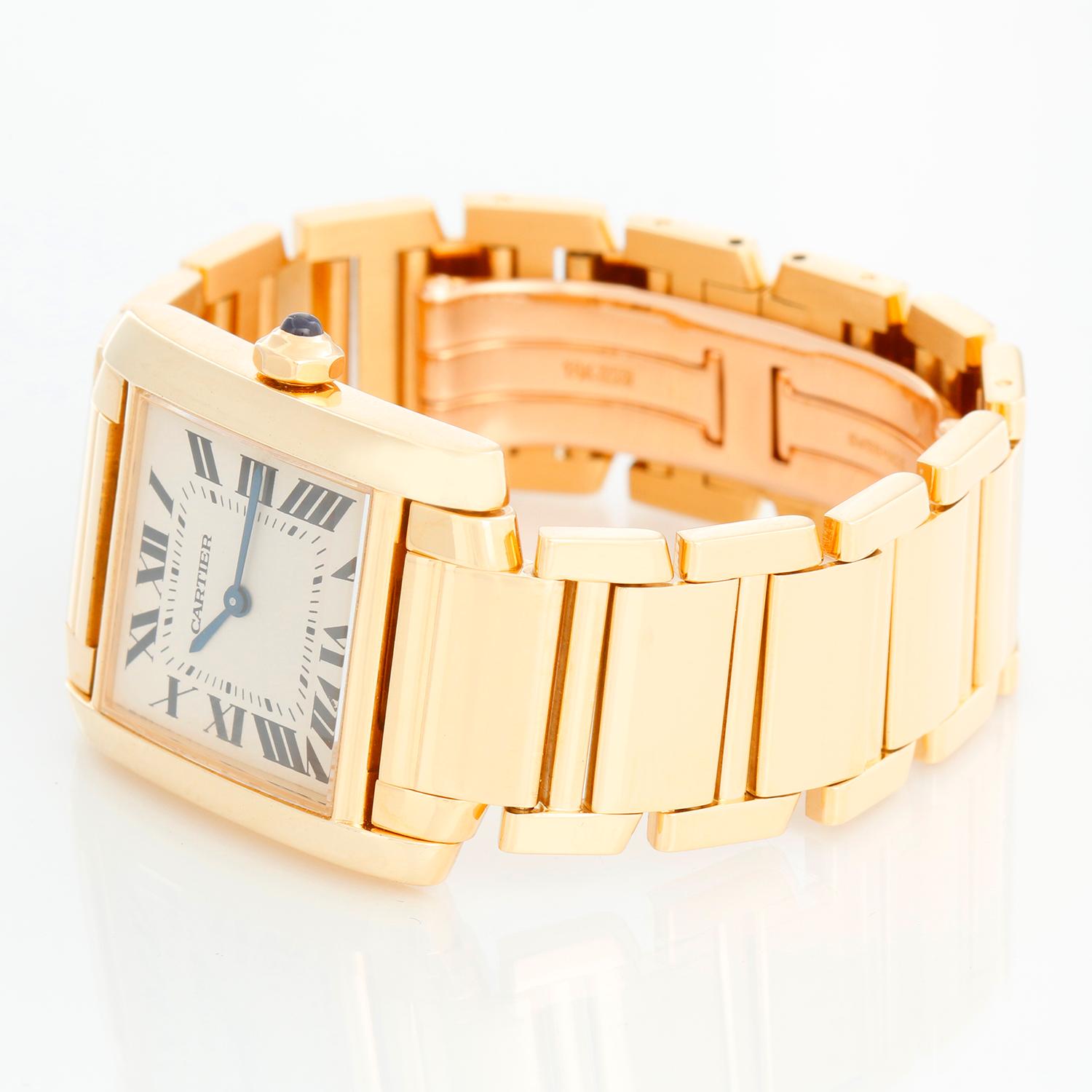 Cartier Tank Francaise Midsize 18k Yellow Gold Watch W50003N2 1821 - Quartz. 18k yellow gold  case; blue sapphire cabochon crown and diamond bezel  (25mm x 30mm). Ivory colored dial with black Roman numerals. 18K Yellow gold bracelet; will fit a 6
