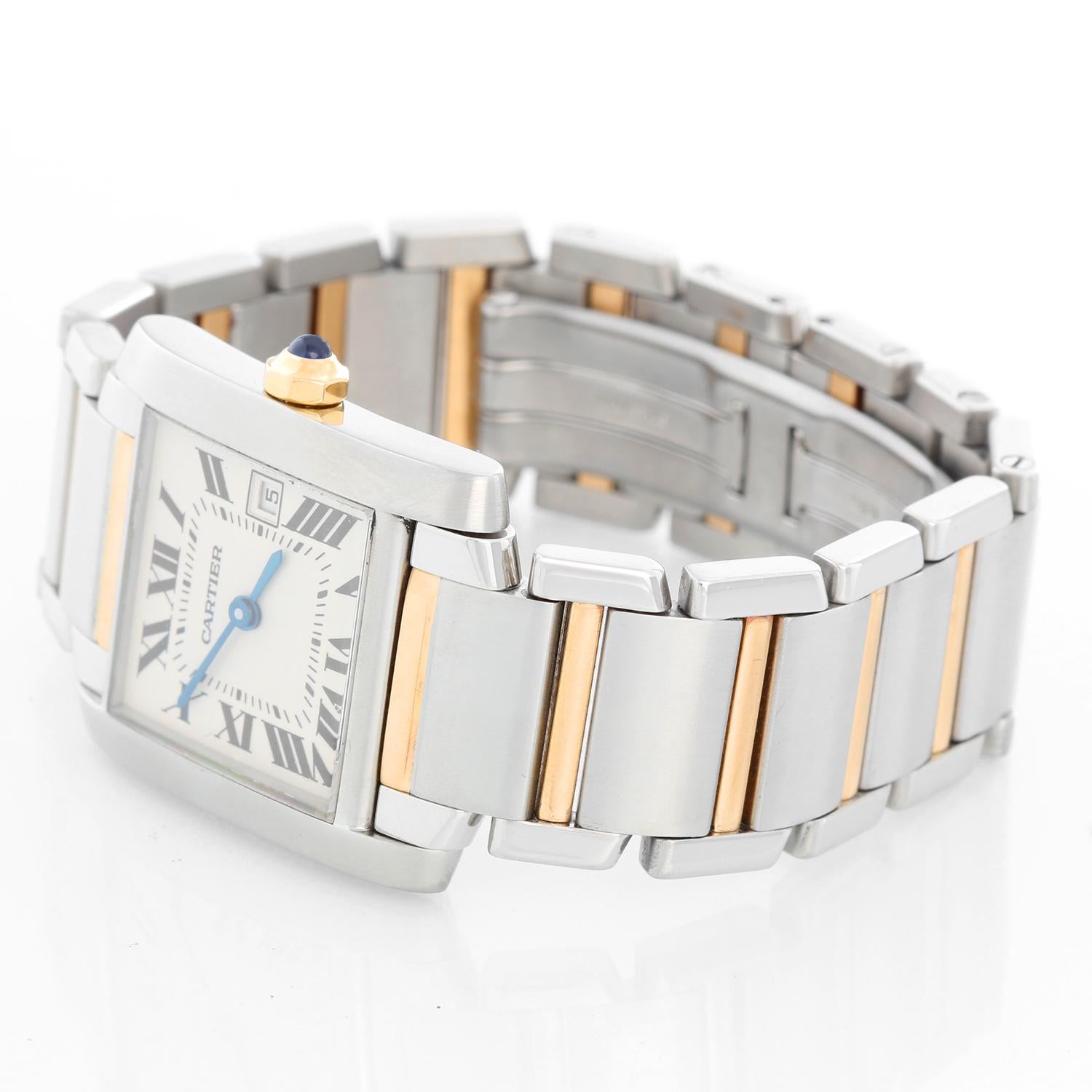 Cartier Tank Francaise Midsize 2-Tone Watch W51005Q4 2465 - Quartz. Stainless steel case (25 x 30 mm). Silver guilloche dial with black Roman numerals; date at 3 o'clock. Stainless steel and 18k yellow gold Cartier bracelet with deployant buckle.