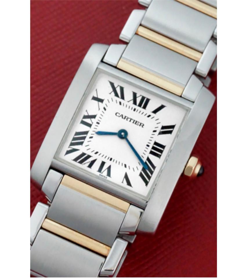 Charming and timeless. This beautiful Cartier Tank Française is in gorgeous condition. This watch features both 18k gold and stainless steel construction. The dial is a silver textured dial that features black Roman numerals. The crown is 18k gold
