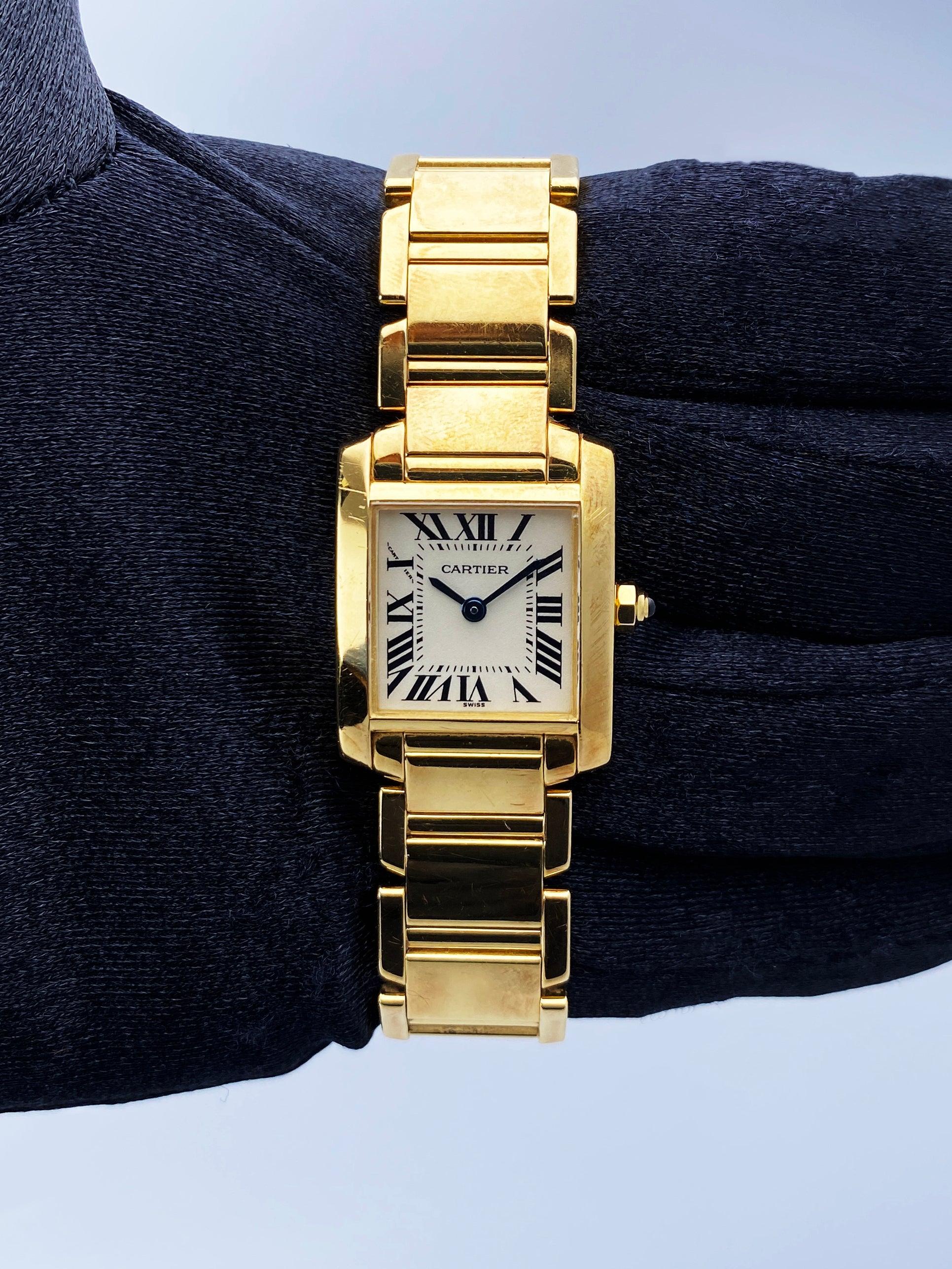Cartier Tank Francaise W50002N2 Ladies Watch. 20mm 18k yellow gold case with 18K yellow gold bezel. Off-White dial with Blue steel hands and Roman numeral hour markers. Minute markers on the inner dial. 18K yellow gold bracelet with hidden