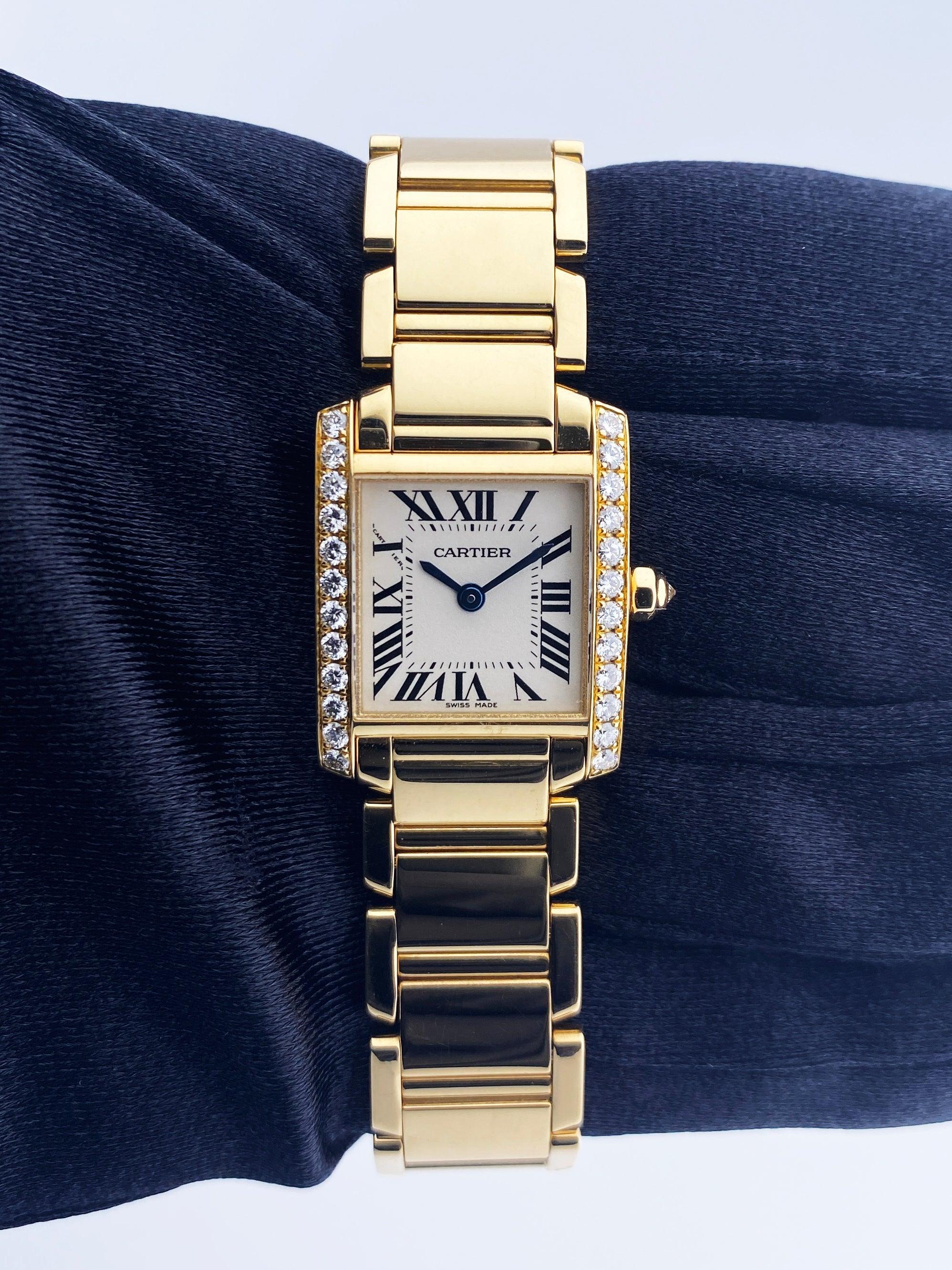 Cartier Tank Francaise 2385 Ladies Watch. 20mm 18k yellow gold case. 18K yellow gold bezel with original factory diamond set insert. Off-White dial with Blue steel hands and Roman numeral hour markers. Minute markers on the inner dial. 18K yellow