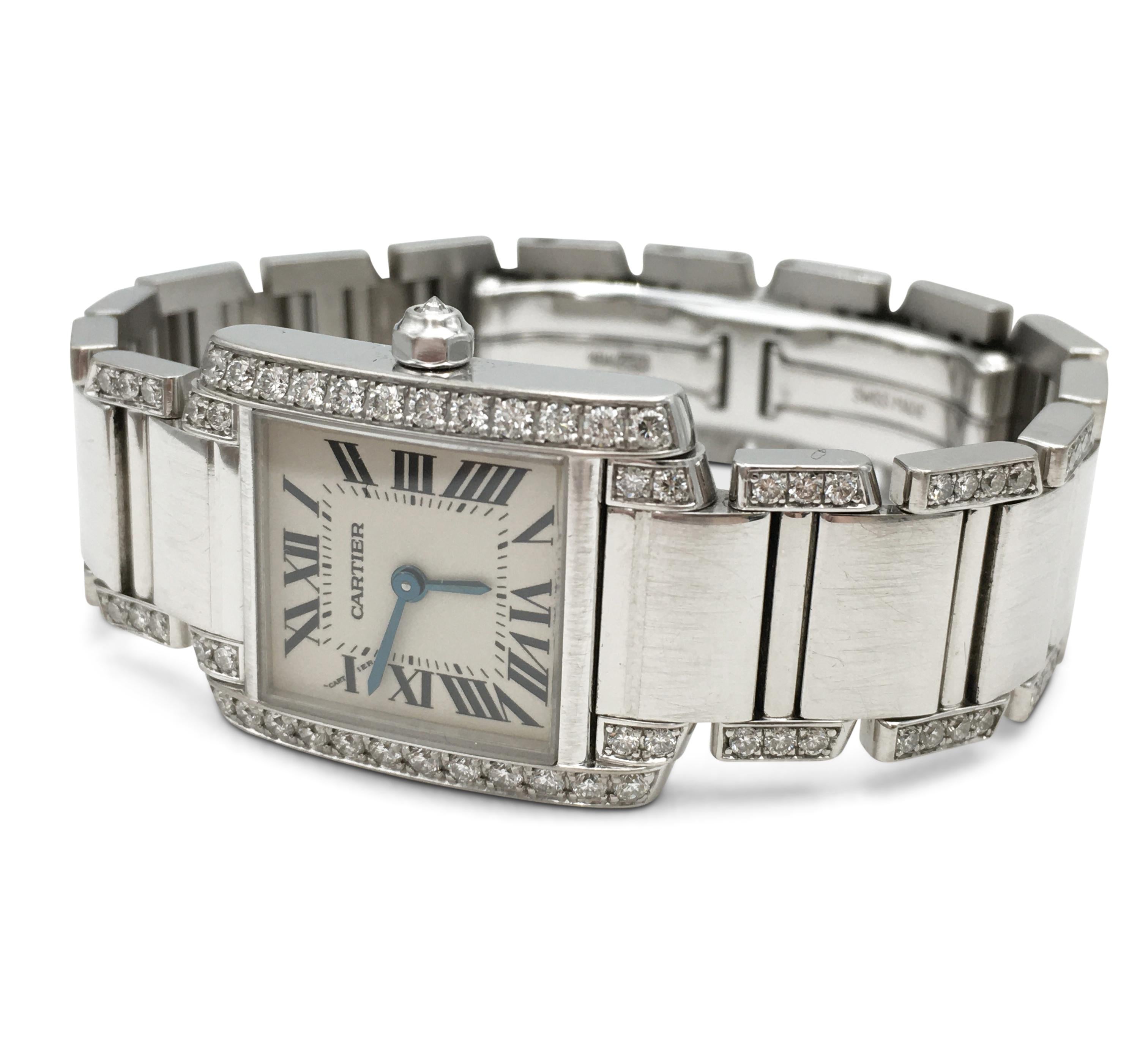 Authentic Cartier 'Tank Francaise' watch crafted in 18 karat white gold. The rectangular case (20 mm x 25 mm) is set with high-quality round brilliant cut diamonds and the octagonal crown is set with one diamond. Silvered dial with painted black