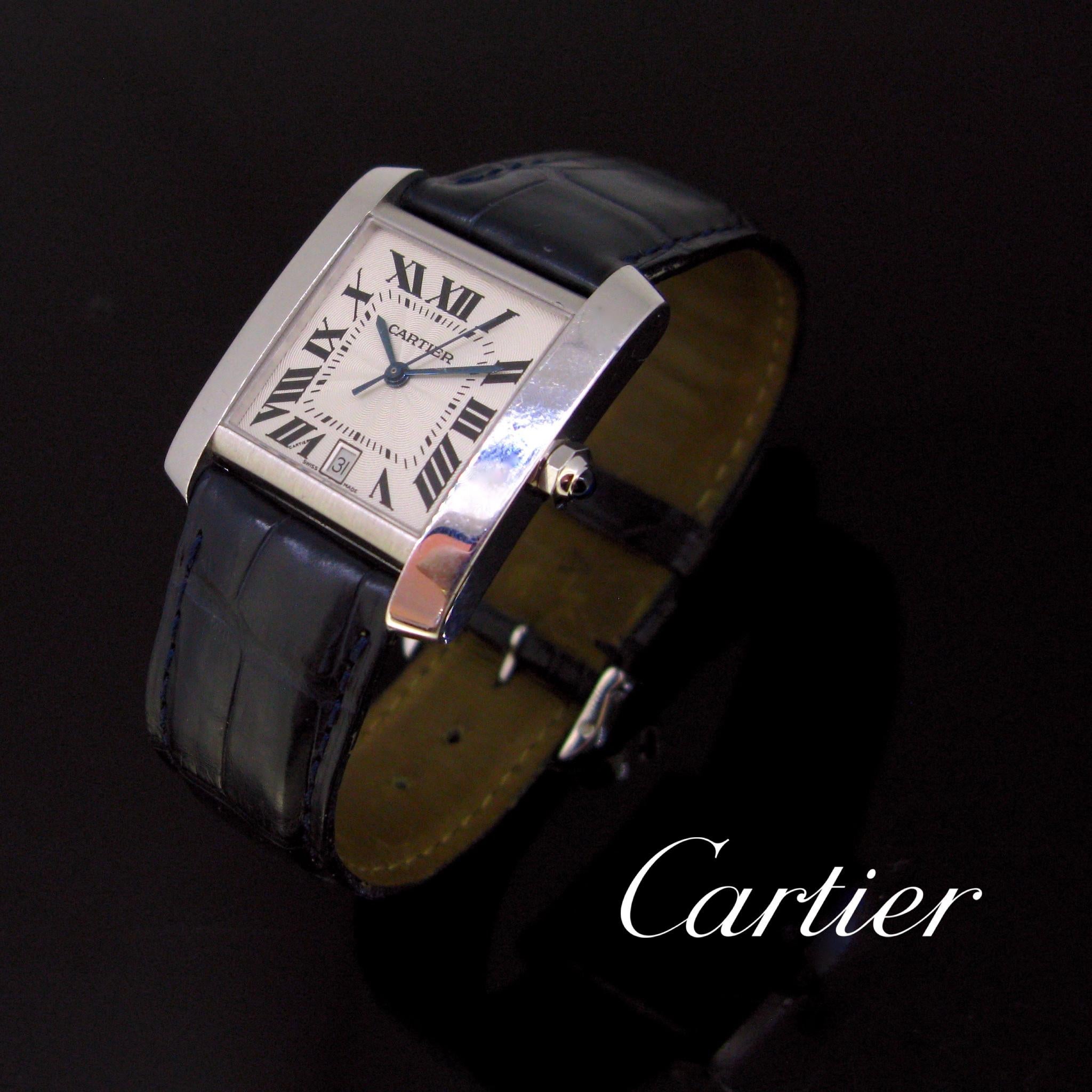 This automatic Cartier Tank Française is made in 18kt white gold. Indices are in roman, there is a blue cabochon sapphire and the date calendar is on the indice 6. It works perfectly. It comes with its original Cartier navy blue strap & buckle. This