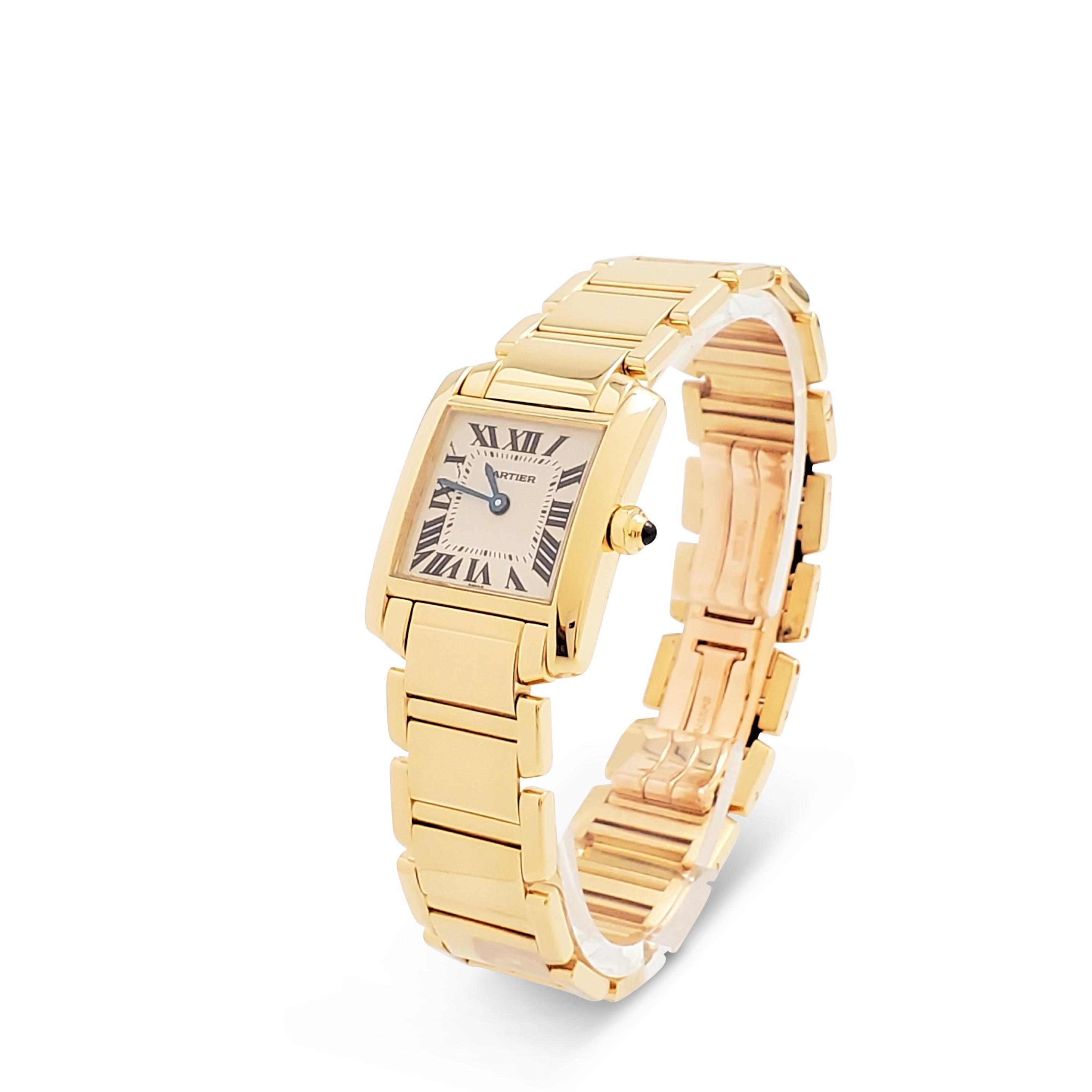 Authentic Cartier 'Tank Française' watch crafted in 18 karat yellow gold features a rectangular case (20 mm x 25 mm) and an octagonal crown that is set with one cabochon sapphire. Silvered dial with painted black Roman numerals, sword-shaped blue