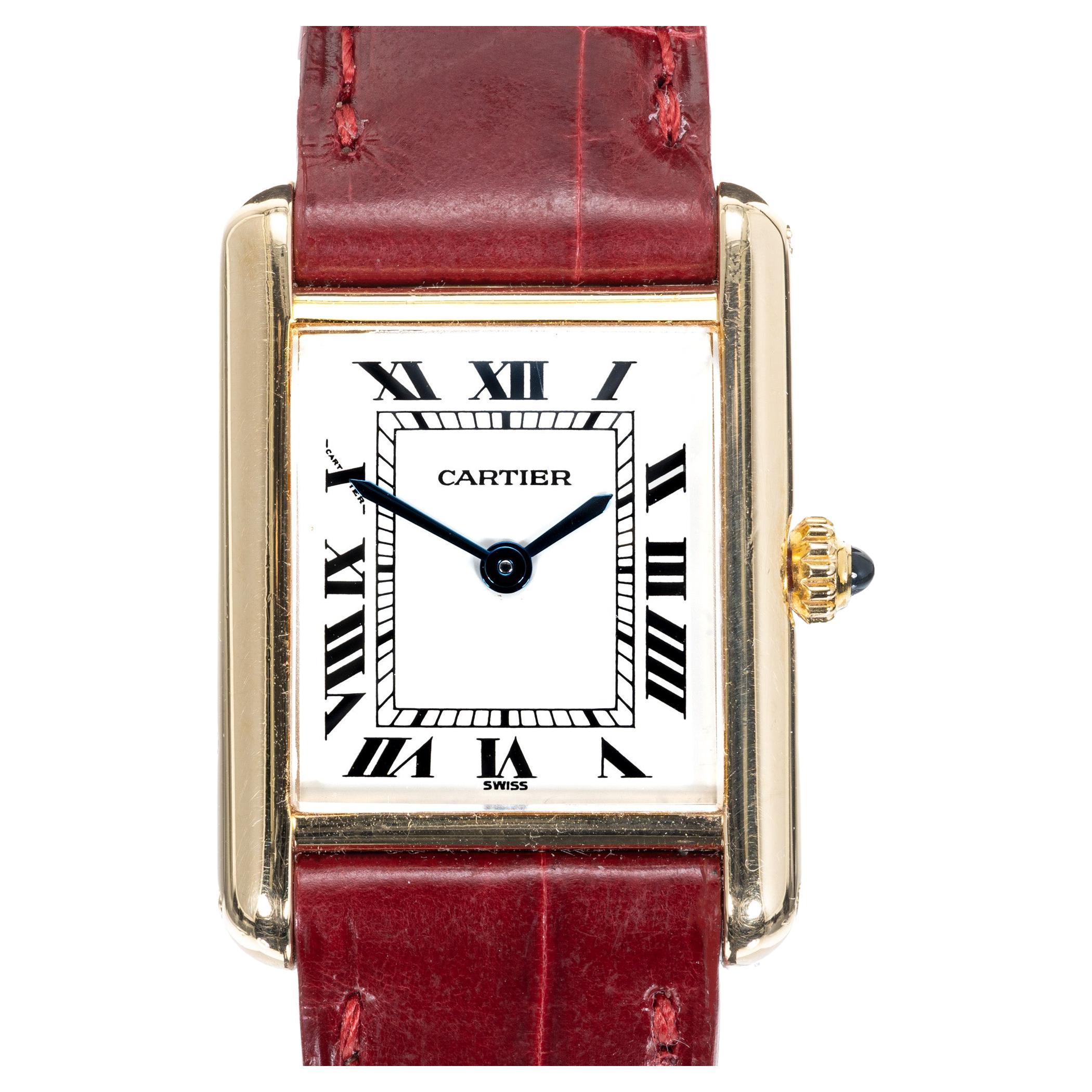 Ladies Cartier tank solo quartz wristwatch with Roman numerals. 18k yellow gold deployant buckle. 

Length: 28mm
Width: 20mm
Band width at case: 15mm
Case thickness: 6.5mm
Band: Original Cartier
Crystal: Sapphire
Dial: Parchment Roman