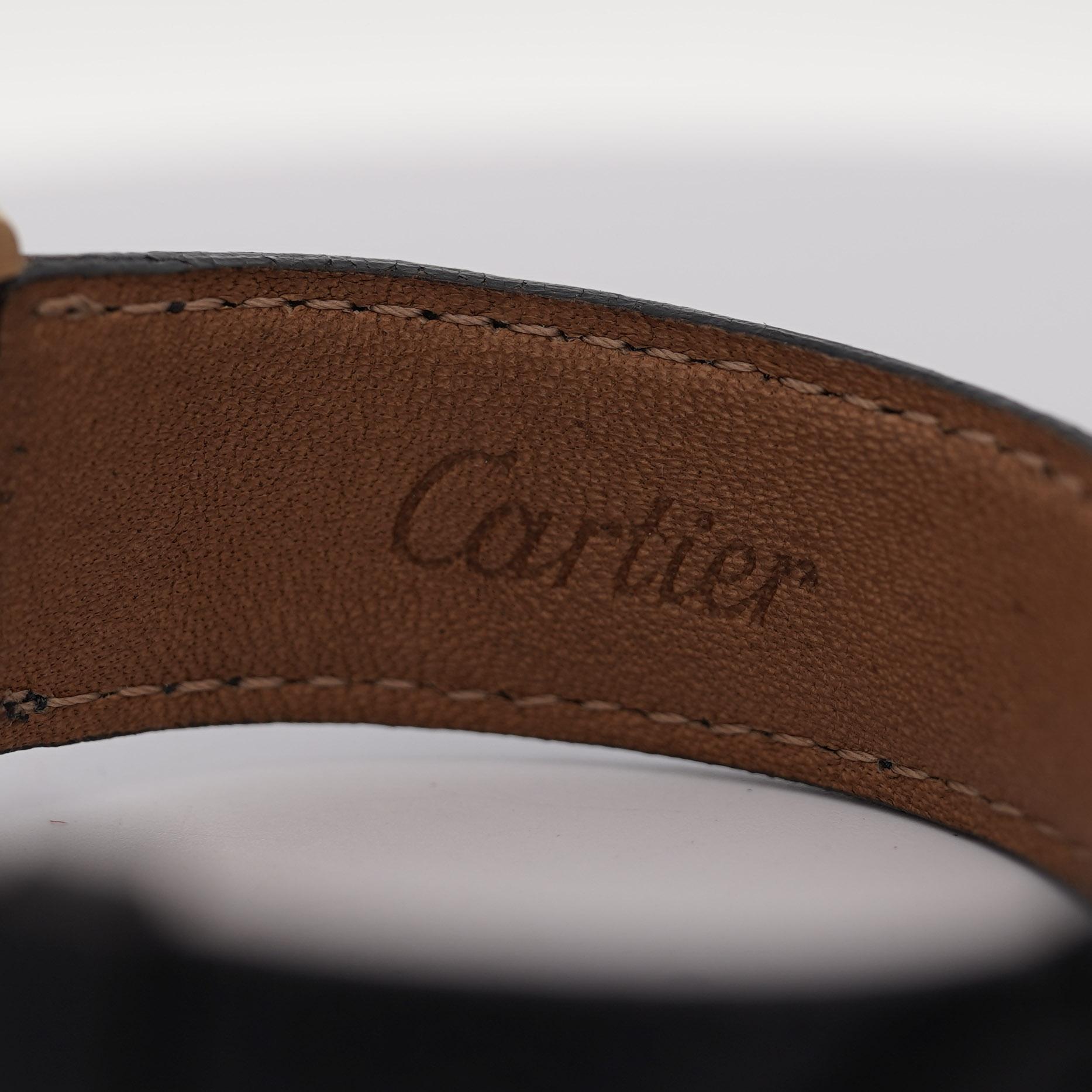 The Cartier Tank, 25mm crafted in 18K yellow gold unisex watch. Roman numerals, original lizard skin strap. Complete with original Cartier Box. No papers, buckle not Cartier or 18k gold. 

Details:
Item Type: Unisex Watch
Metal: 18K Yellow Gold
Case
