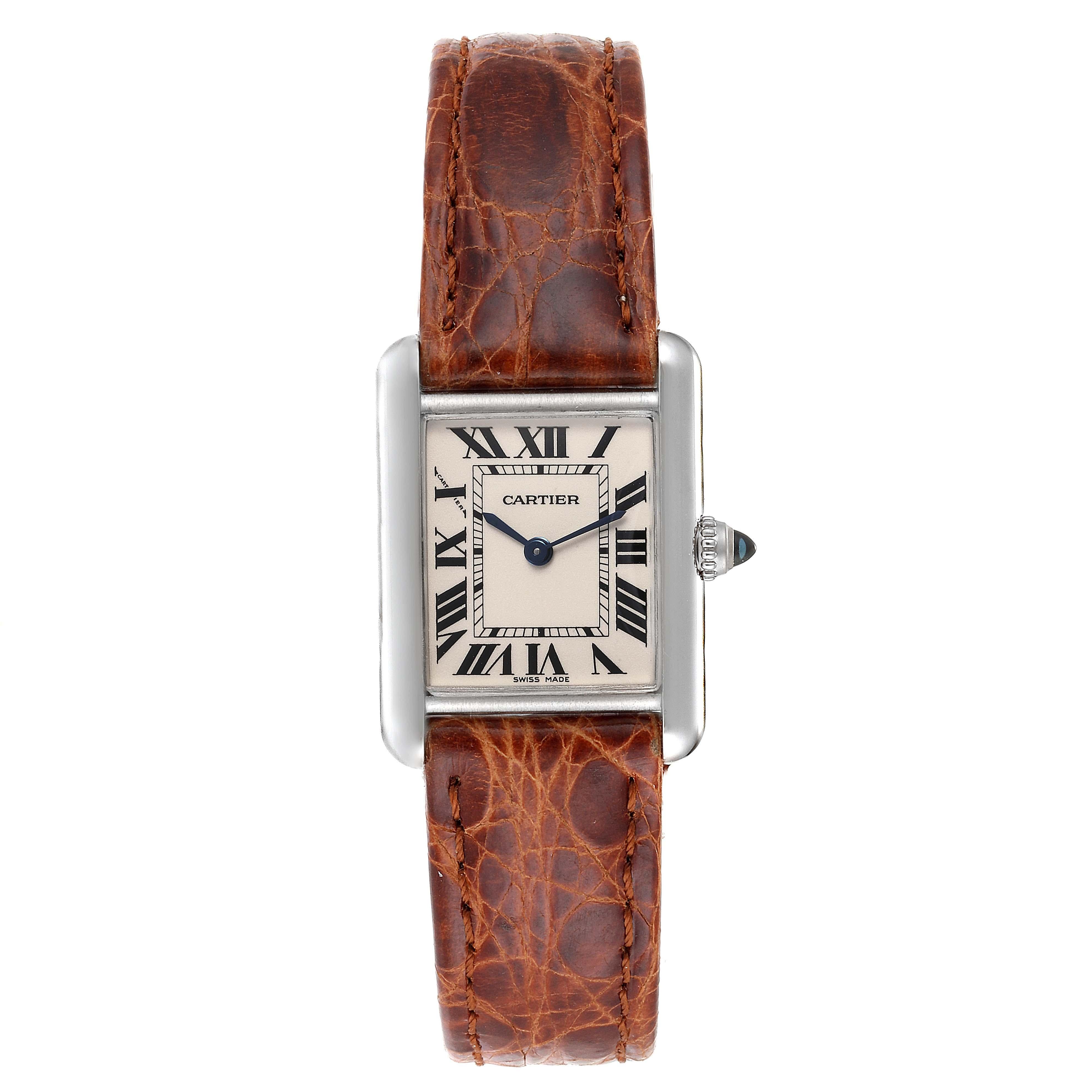 Cartier Tank Louis 18k White Gold Brown Strap Ladies Watch W1541056. Quartz movement. 18K white gold case 21.7 x 29.3 mm. Circular grained crown set with the blue sapphire cabochon. . Scratch resistant sapphire crystal. Silvered grained dial with