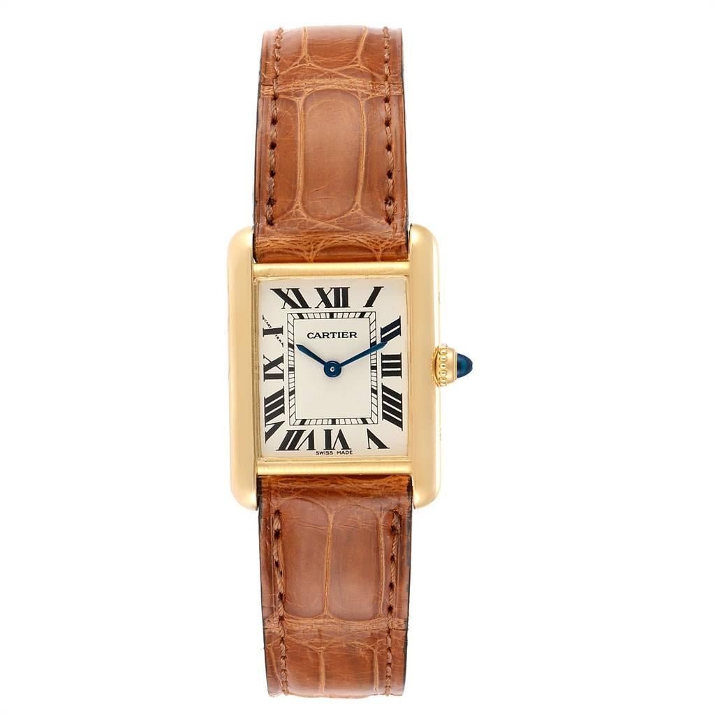 Cartier Tank Louis 18k Yellow Gold Brown Strap Ladies Watch W1529856. Quartz movement. 18k yellow gold case 29.0 x 22.0 mm. Circular grained crown set with the blue sapphire cabochon. Scratch resistant sapphire crystal. Silvered grained dial.