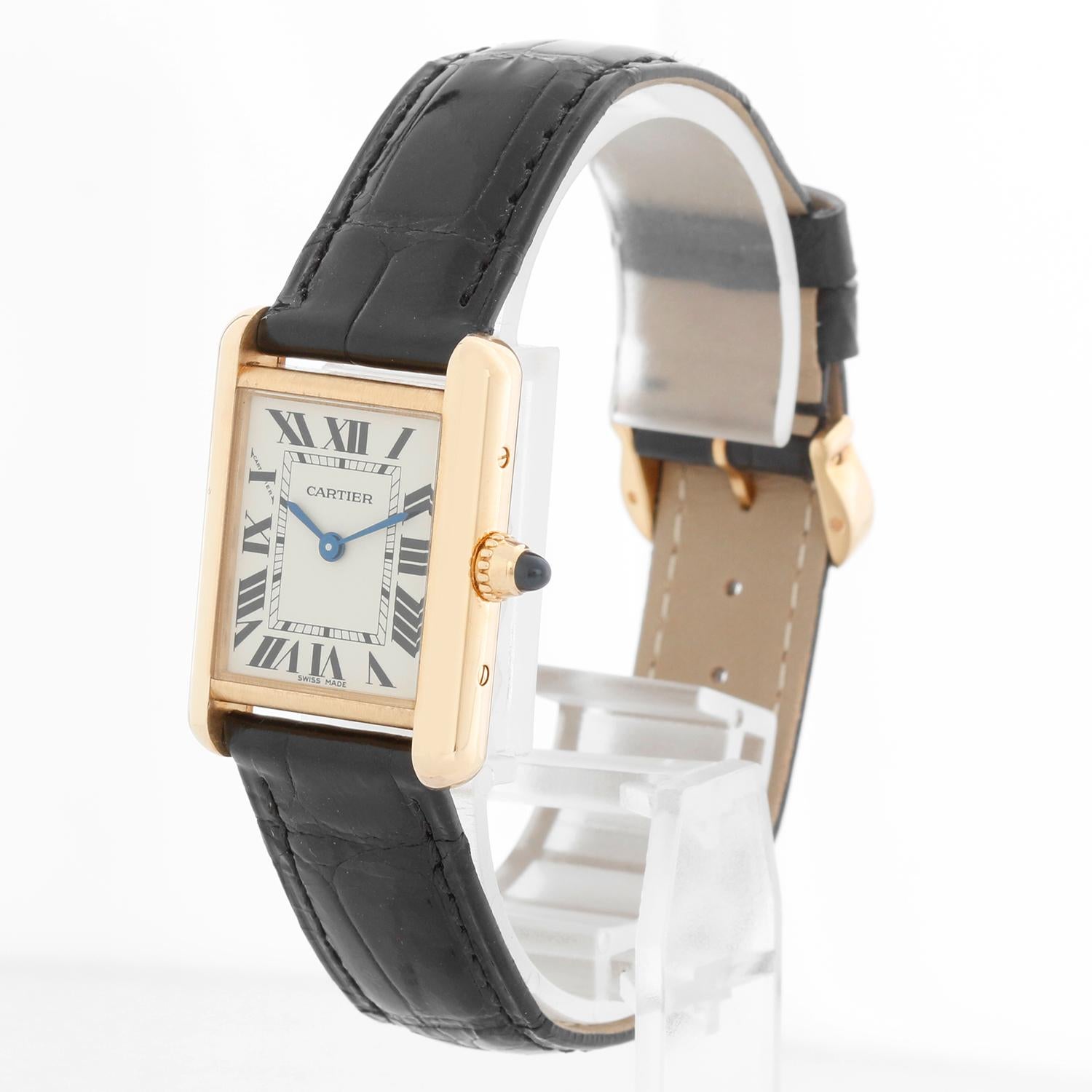 Cartier Tank Louis 18k Yellow Gold Ladies Watch on Leather Band 2442 - Quartz. 18k yellow gold case (22mm x 30mm). Ivory colored dial with black Roman numerals. New Cartier Strap band with 18k yellow gold Cartier buckle. Pre-owned with Cartier Box.