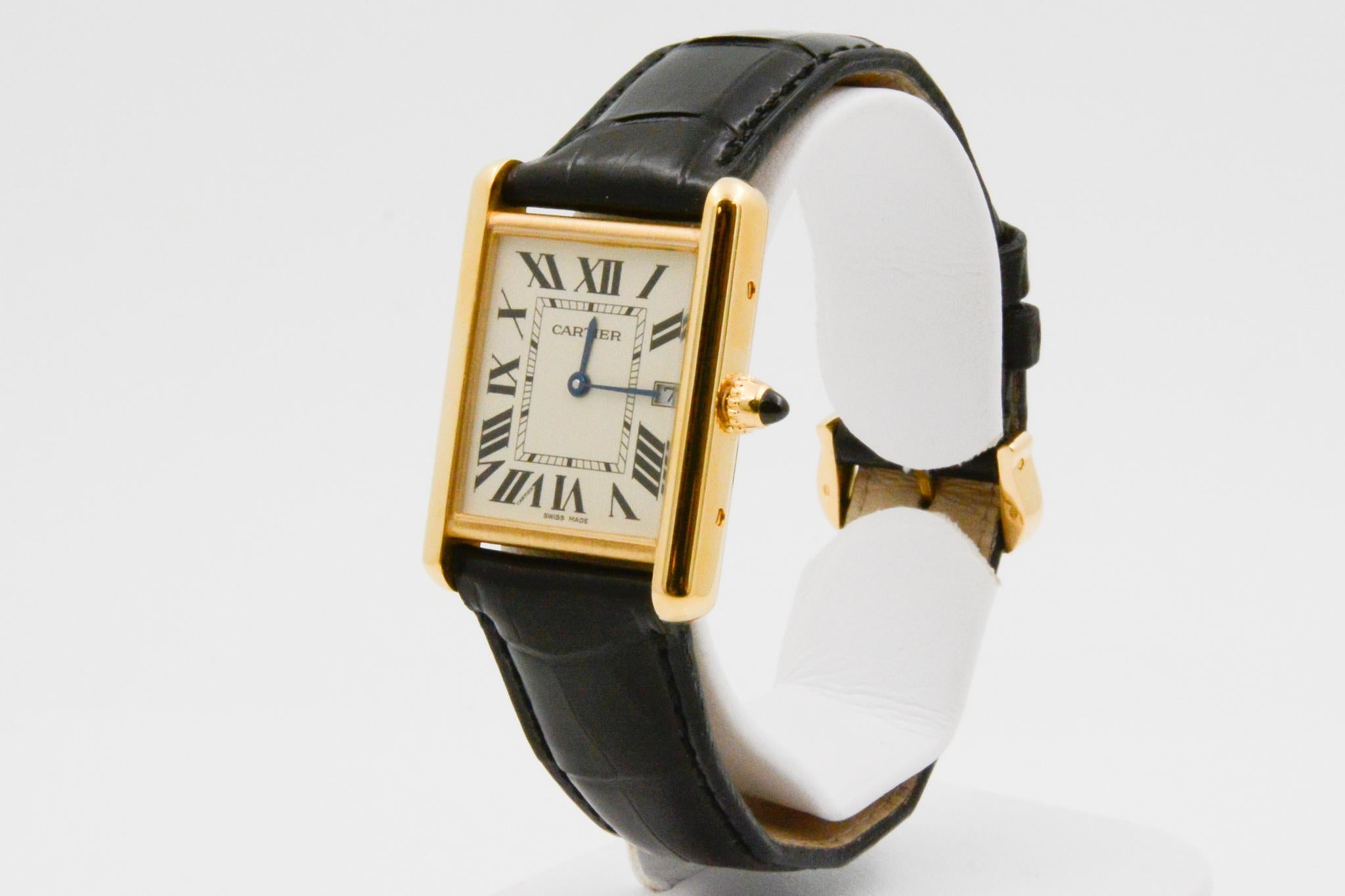 This circa 2012 CPO Cartier Tank Louis has a large 18k yellow gold silver roman dial, sapphire crystal and a black alligator strap. The watch has an 18k yellow gold buckle and quartz movement. 

