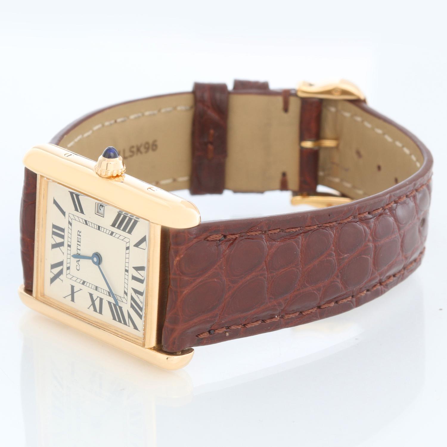Cartier Tank Louis 18K Yellow Unisex Gold Watch W1529756 2441 - Quartz. 18K Yellow Gold ( 26 x 34 mm ). Flat Ivory dial with Roman numerals; date at 3 o'clock. Cartier alligator strap with Cartier tang gold buckle. Pre-owned with Custom box.