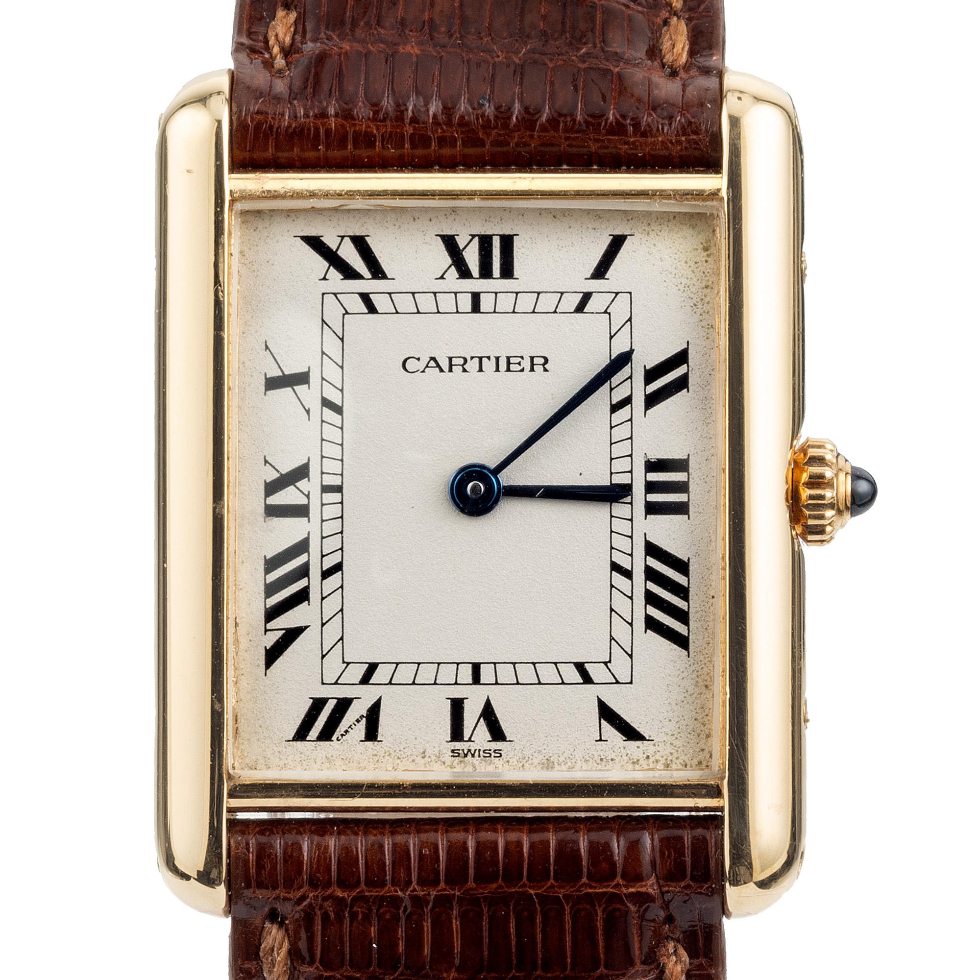Cartier Tank Louis wristwatch. The sleek rectangular 18k yellow gold 23mm case is a hallmark of Cartier's timeless heritage and craftsmanship. Parchment Roman numeral dial and new Cartier band. 18k Cartier buckle. The absence of a date feature
