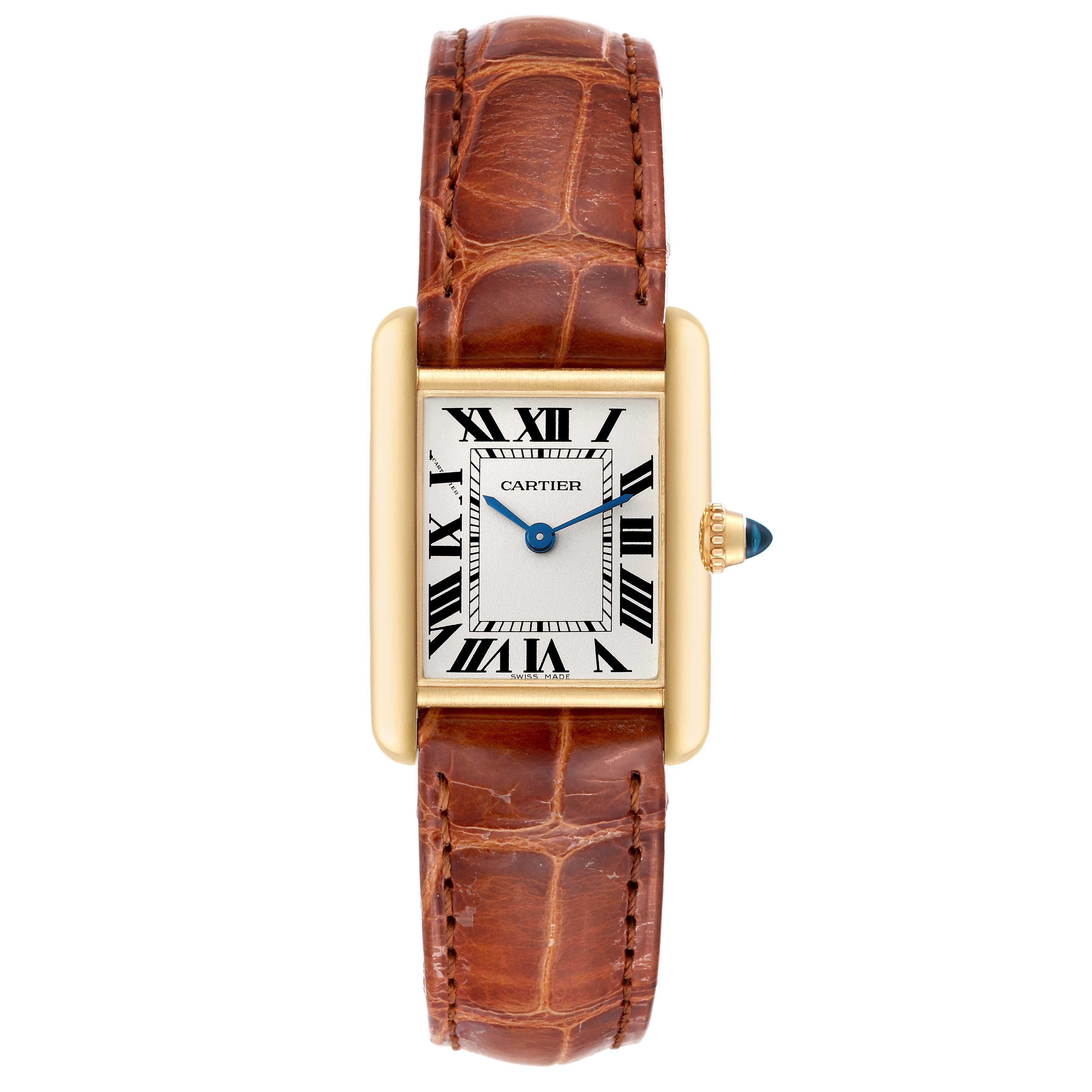 Cartier Tank Louis Small Yellow Gold Brown Strap Ladies Watch W1529856 Box Card. Quartz movement. 18k yellow gold case 29.0 x 22.0 mm. Circular grained crown set with a blue sapphire cabochon. . Scratch resistant sapphire crystal. Silvered grained