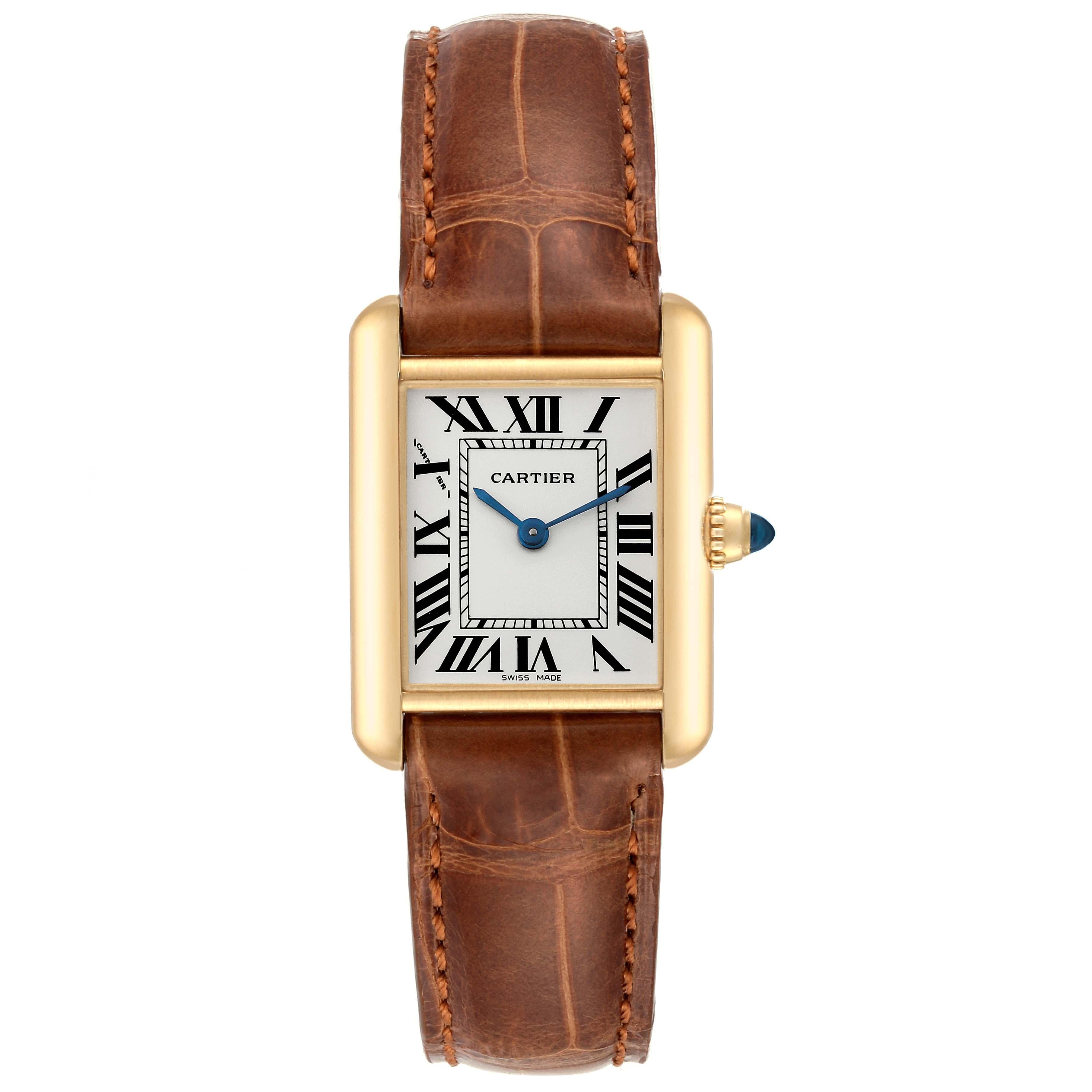 Cartier Tank Louis Small Yellow Gold Brown Strap Ladies Watch W1529856. Quartz movement. 18k yellow gold case 29.0 x 22.0 mm. Circular grained crown set with a blue sapphire cabochon. . Scratch resistant sapphire crystal. Silvered grained dial with