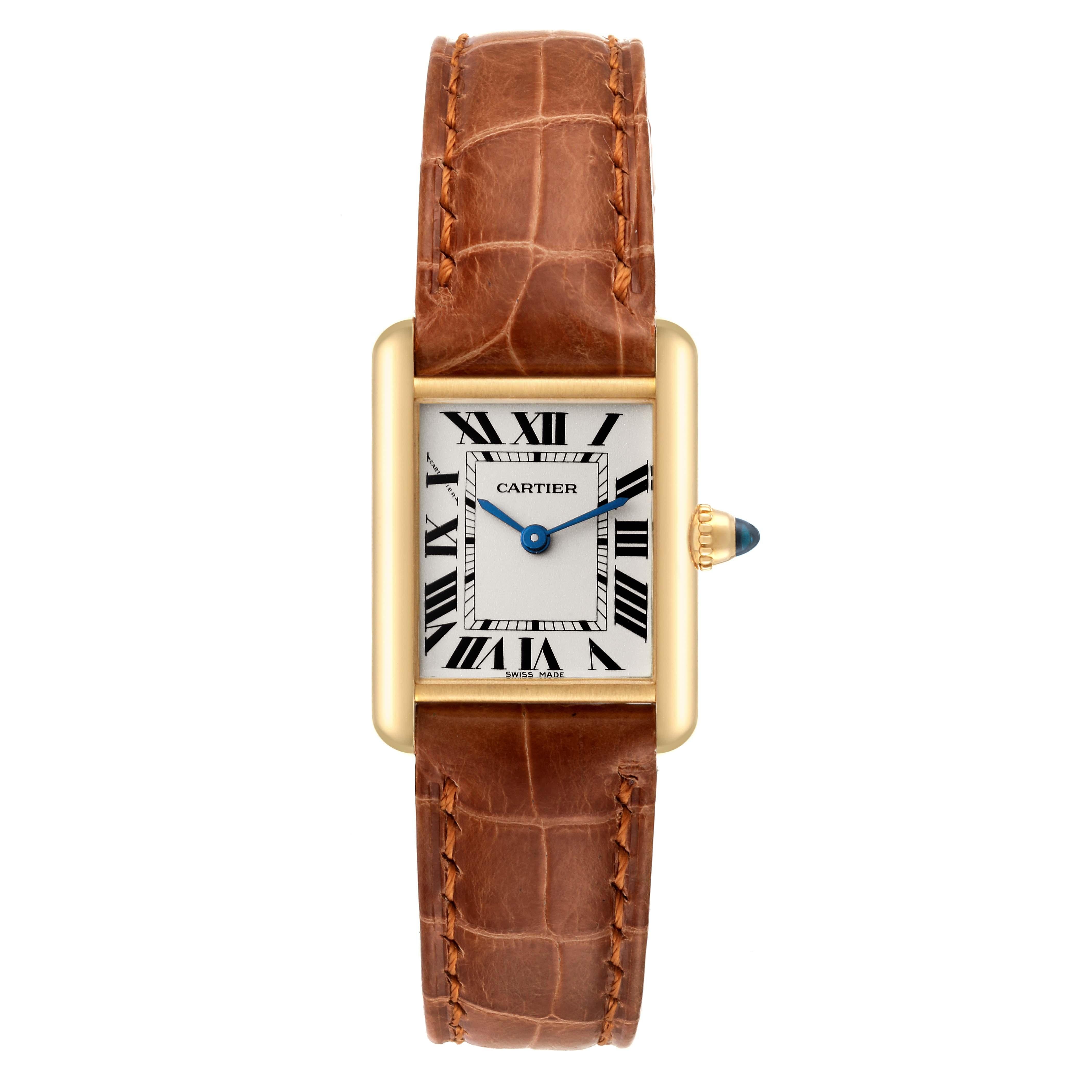 Cartier Tank Louis Small Yellow Gold Brown Strap Ladies Watch W1529856. Quartz movement. 18k yellow gold case 29.0 x 22.0 mm. Circular grained crown set with a blue sapphire cabochon. . Scratch resistant sapphire crystal. Silvered grained dial with