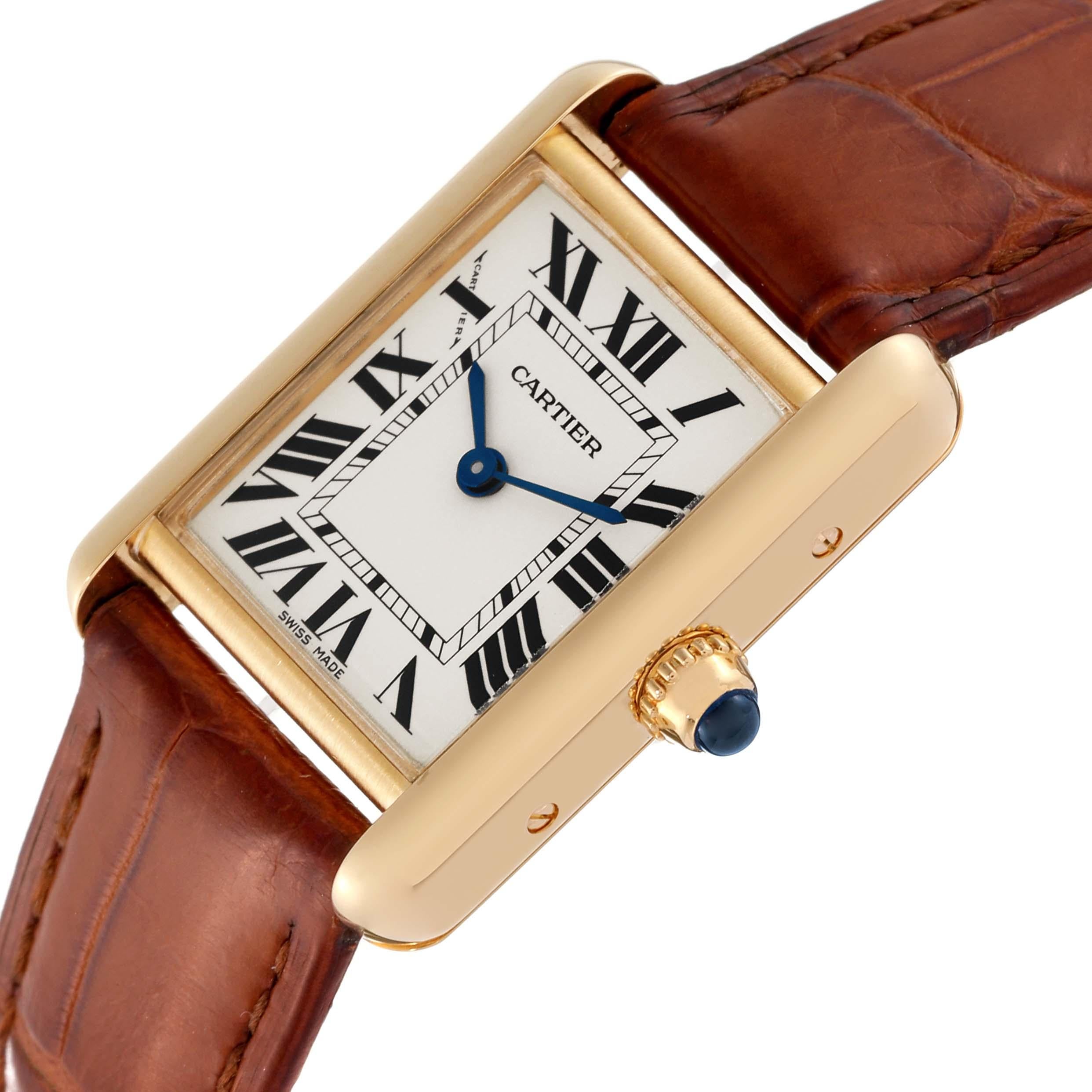 Cartier Tank Louis Small Yellow Gold Brown Strap Ladies Watch W1529856. Quartz movement. 18k yellow gold case 29.0 x 22.0 mm. Circular grained crown set with a blue sapphire cabochon. . Scratch resistant mineral crystal. Silvered grained dial with