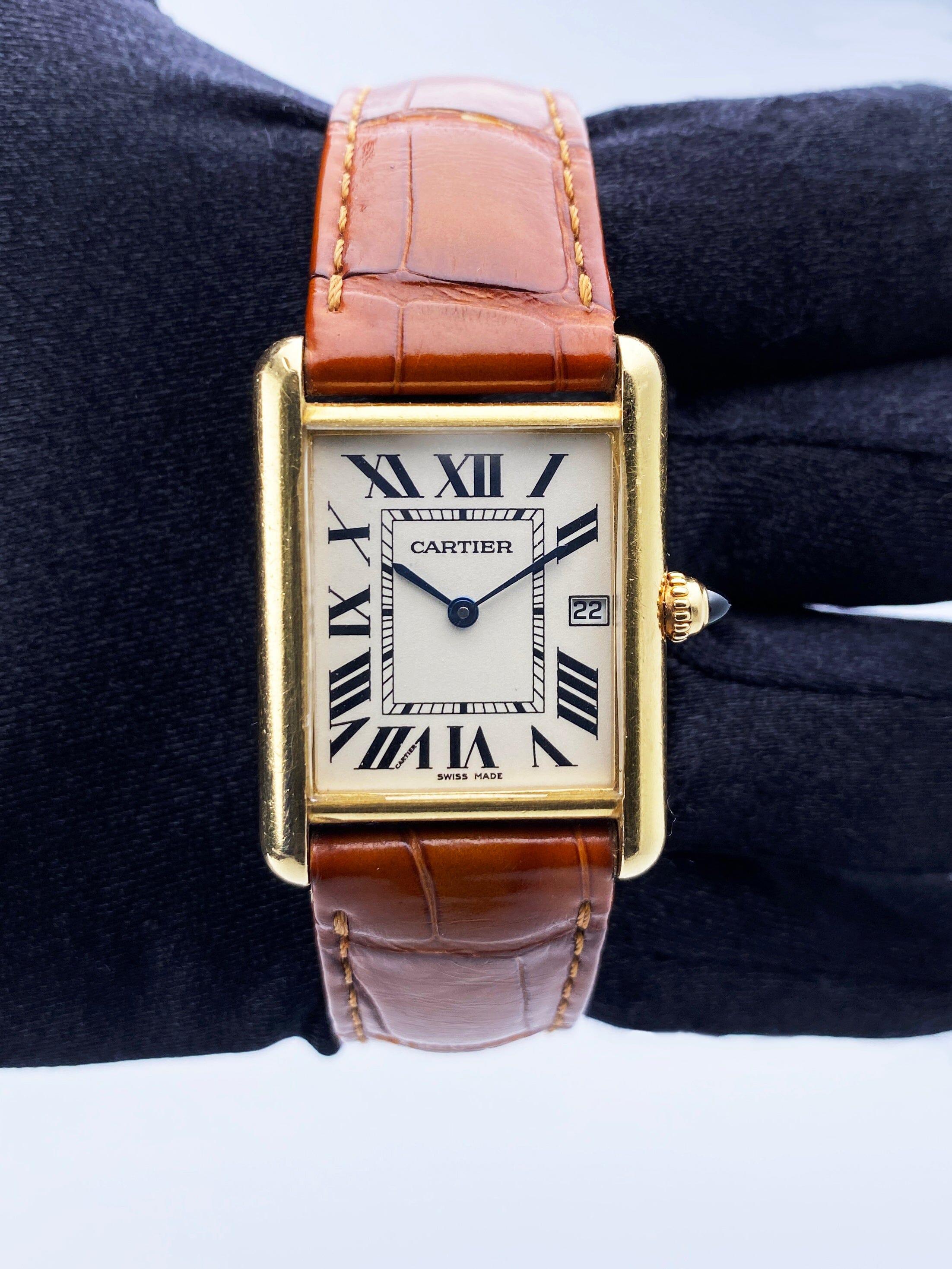 Cartier Tank Louis W1529756 / 2441 Mens Watch. 25.5mm 18K yellow gold case. Off-white dial with blue hands and black Roman numeral hour markers. Minute markers on the inner dial. Date display at 3 o'clock position. Brown leather strap with 18K