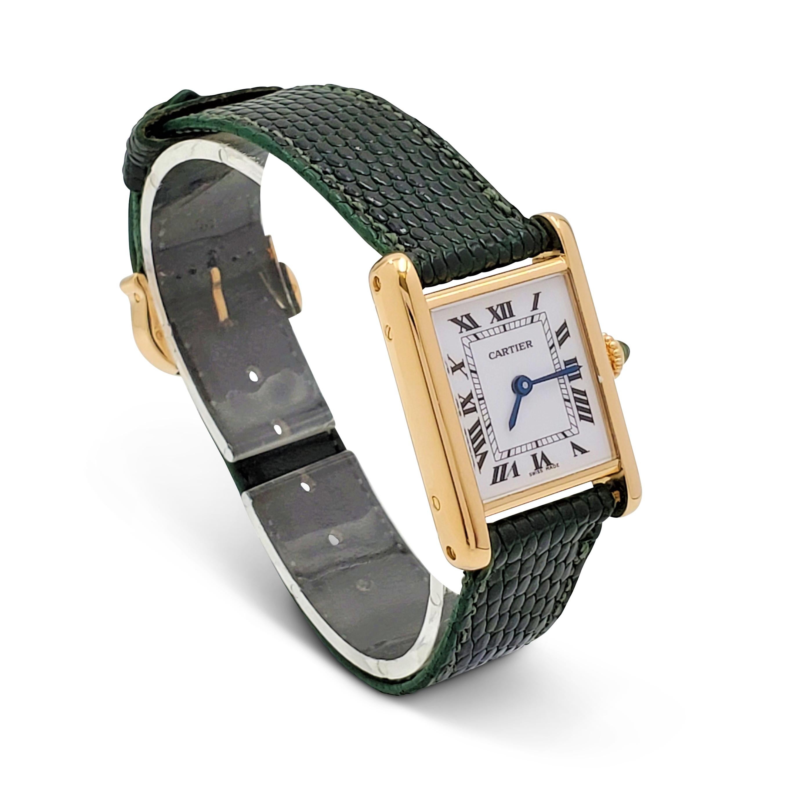 Authentic Cartier 'Tank Louis' ladies watch crafted in 18 karat yellow gold features a classic rectangular case measuring 28 x 20 mm. The porcelain dial is in pristine condition, with black Roman numerals and blued-steel sword-shaped hands. Secret