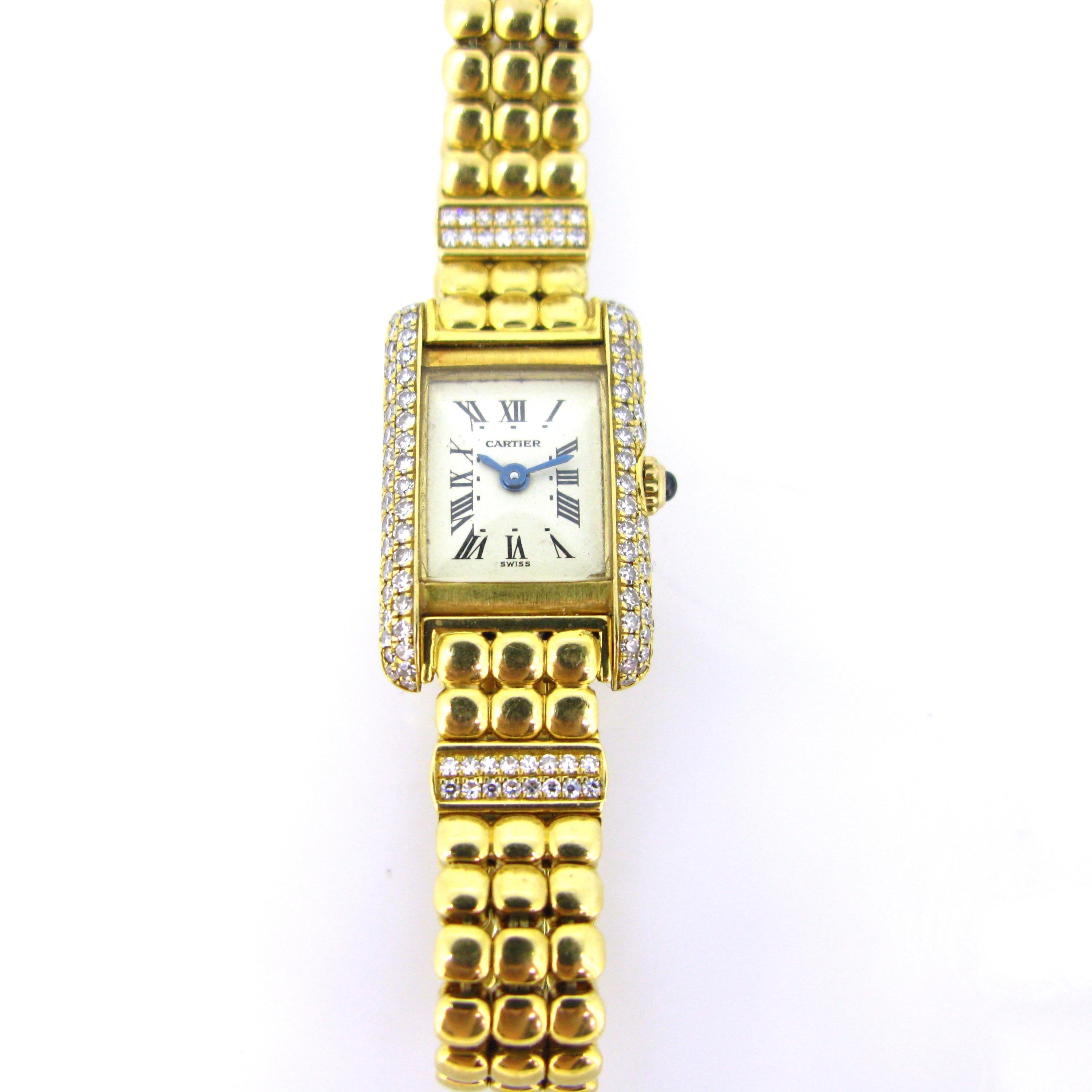 This lady’s quartz wristwatch is fully made in 18kt gold and adorned with single cut diamonds. It is the Tank Mini Model. The Tank line was created by Louis Cartier in 1917. The button is adorned with a cabochon sapphire. The concealed double