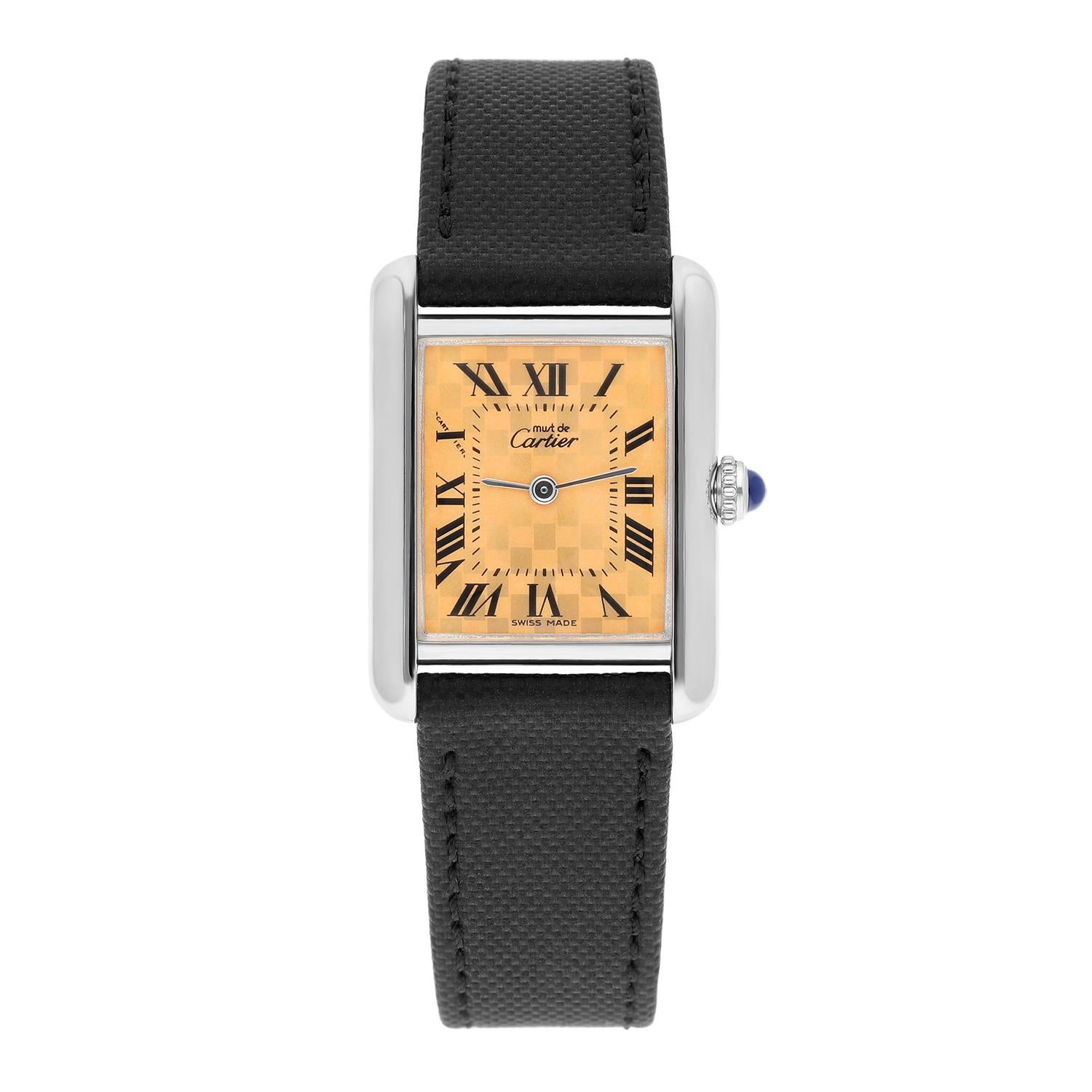 This exquisite Cartier Must de Cartier Tank wristwatch is a timeless classic that boasts a stunning design. Crafted in Switzerland, it features a 22x30mm sterling silver case with a silver bezel and a Orange dial with Roman numerals. The watch is