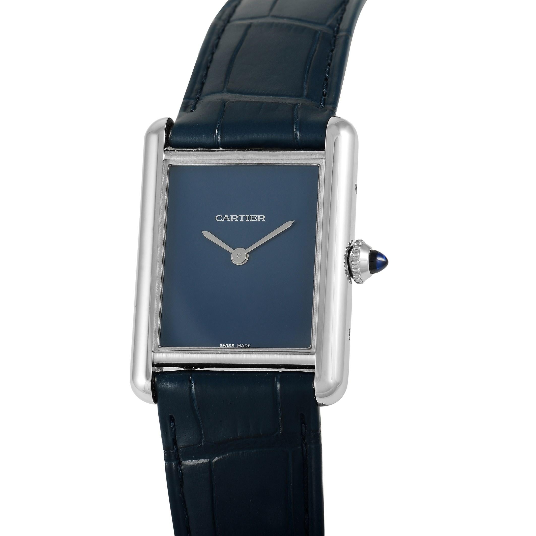 This Cartier watch, reference number WSTA0055, features a stainless steel case that measures 33.7 mm x 25.5 mm. It is presented on a sleek navy alligator leather bracelet with a tang clasp. The deep blue dial displays hours and minutes. This model