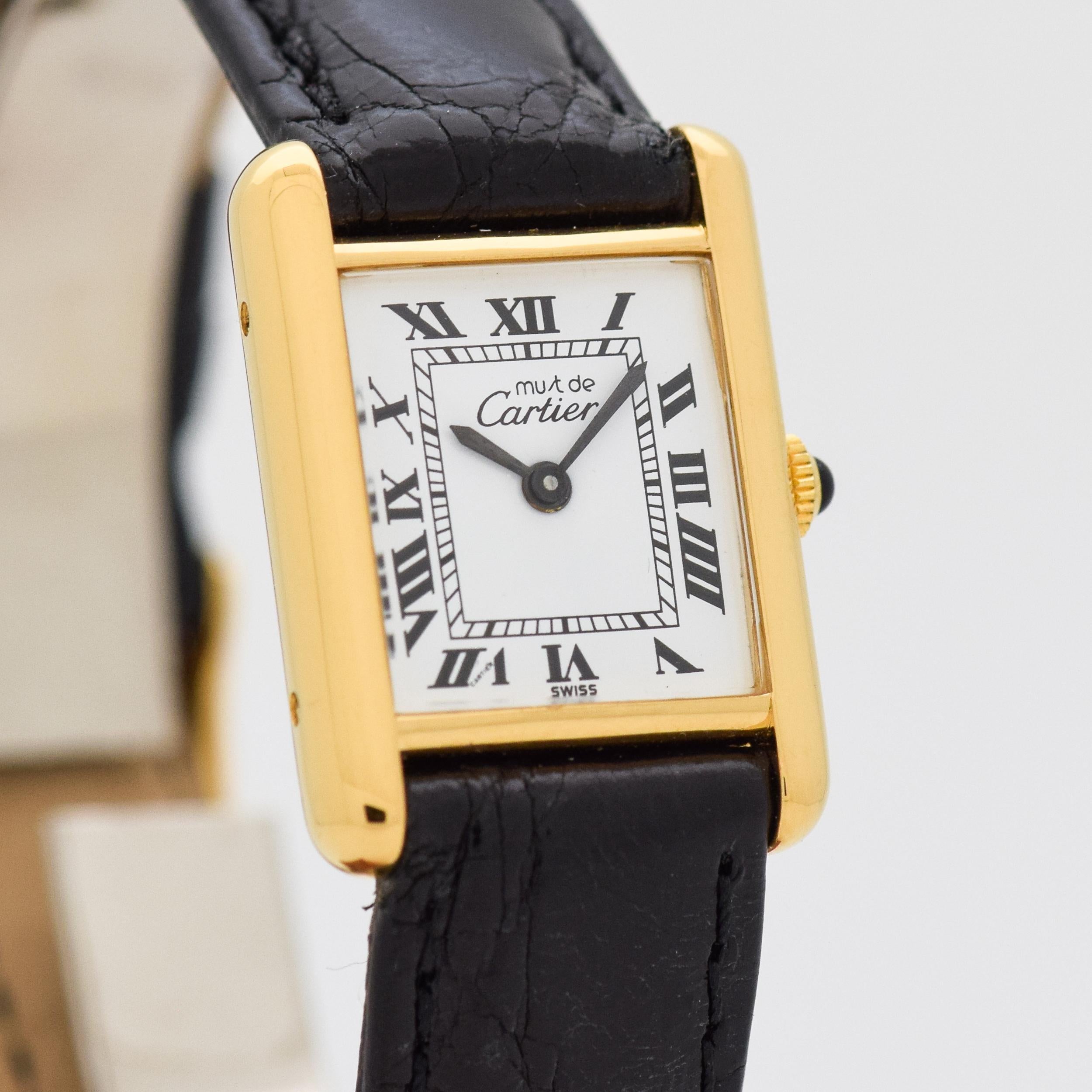 1980's Vintage Cartier Ladies Classic Size Must de Tank 18k Yellow Gold Plated Over Sterling Silver watch with Original White Dial with Black Roman Numerals. 20mm x 27mm lug to lug (0.79 in. x 1.06 in.) - 17 jewel, manual caliber ETA movement. 100%