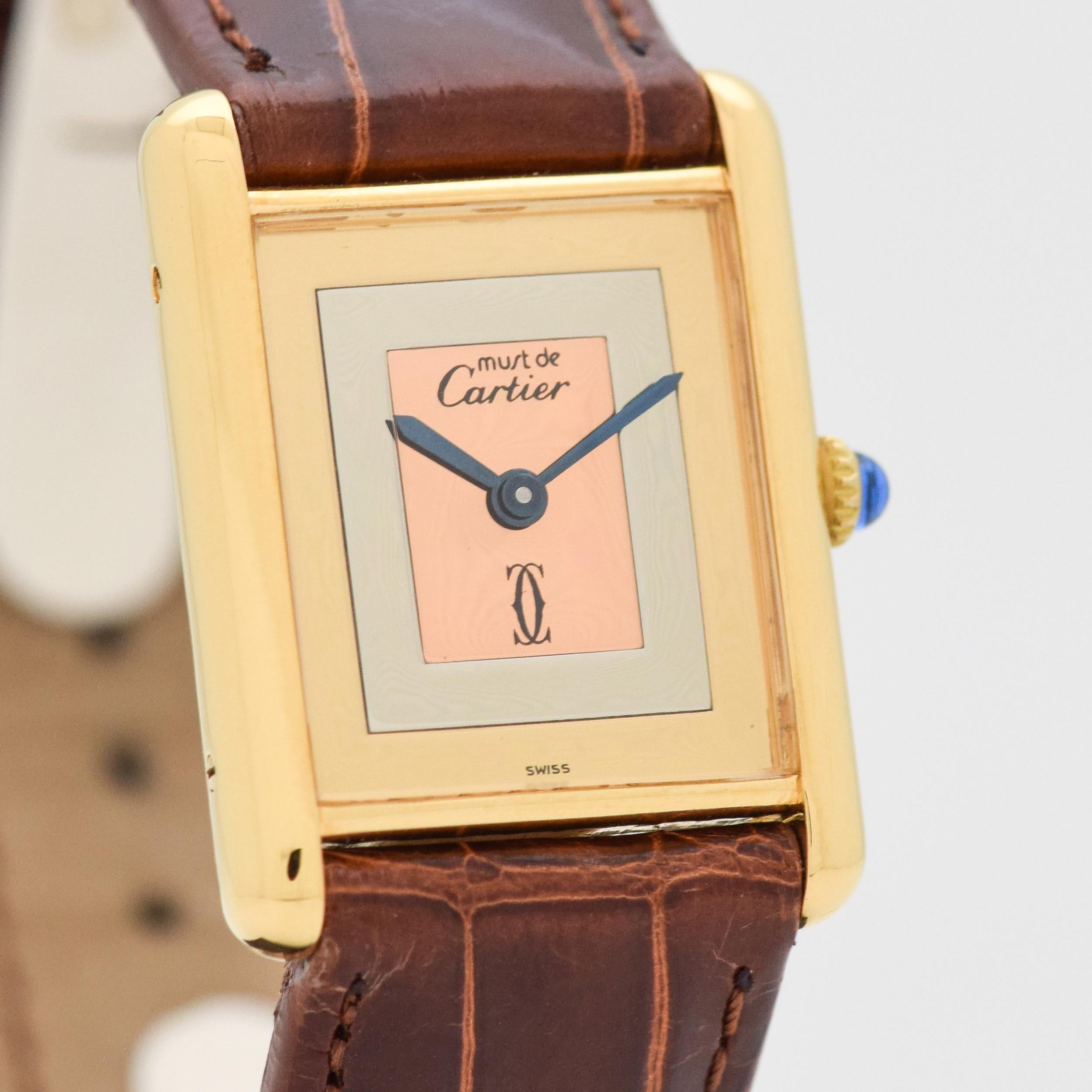 1980's era Cartier Tank Must de Men's Sized Watch. 18K Yellow Gold Plated over Sterling Silver case. Case size, 23mm wide. Tri-color dial. Powered by a 17-jewel, manual caliber movement. Equipped with original, Cartier papers. Swiss-made.