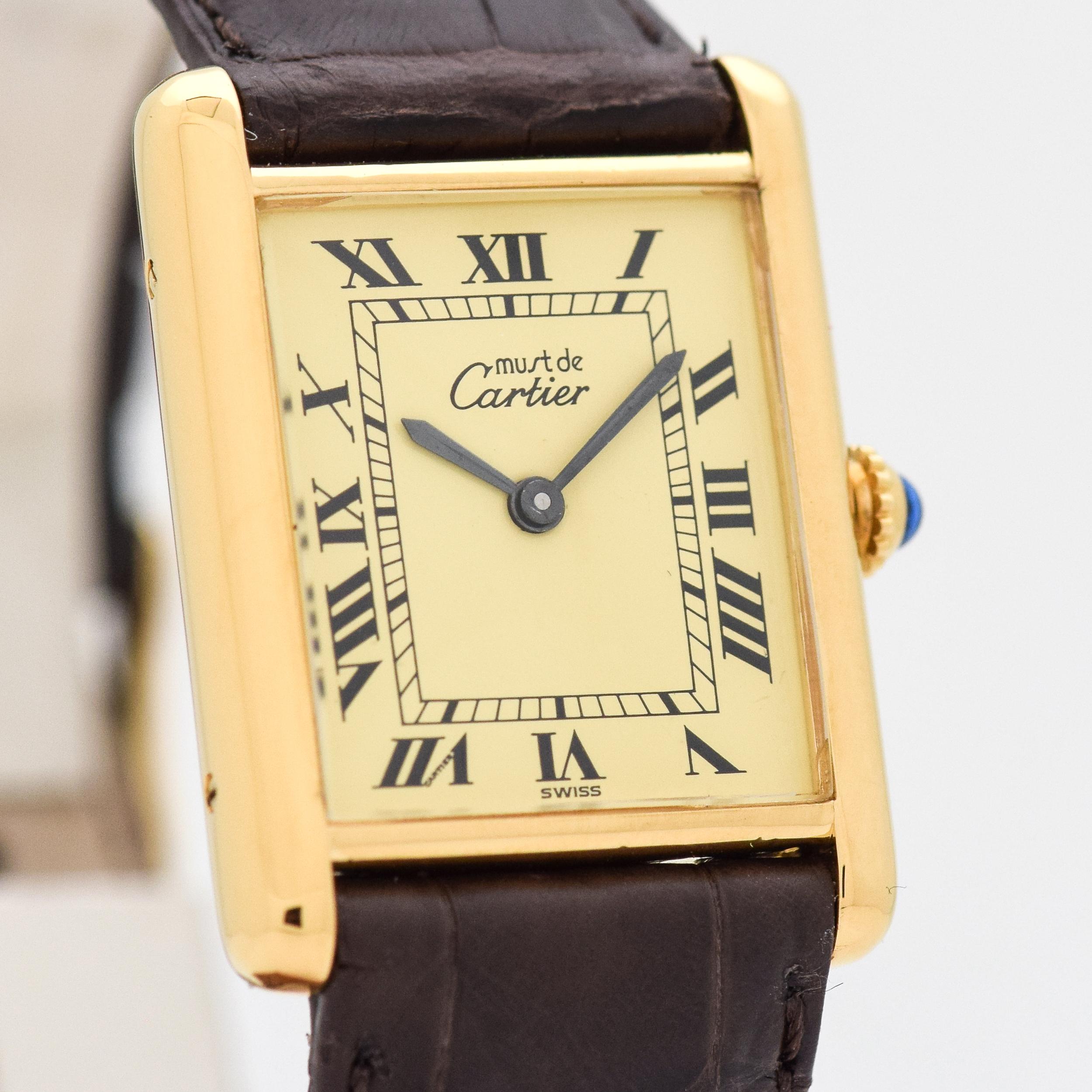 1990's Vintage Cartier Standard Men's Size Tank 18k Yellow Gold Plated Over Sterling Manual Wind watch with Original Gold/Champagne Dial with Black Roman Numerals. Suitable for a Man or a Woman. 23mm x 30mm lug to lug (0.91 in. x 1.18 in.) 17 jewel,