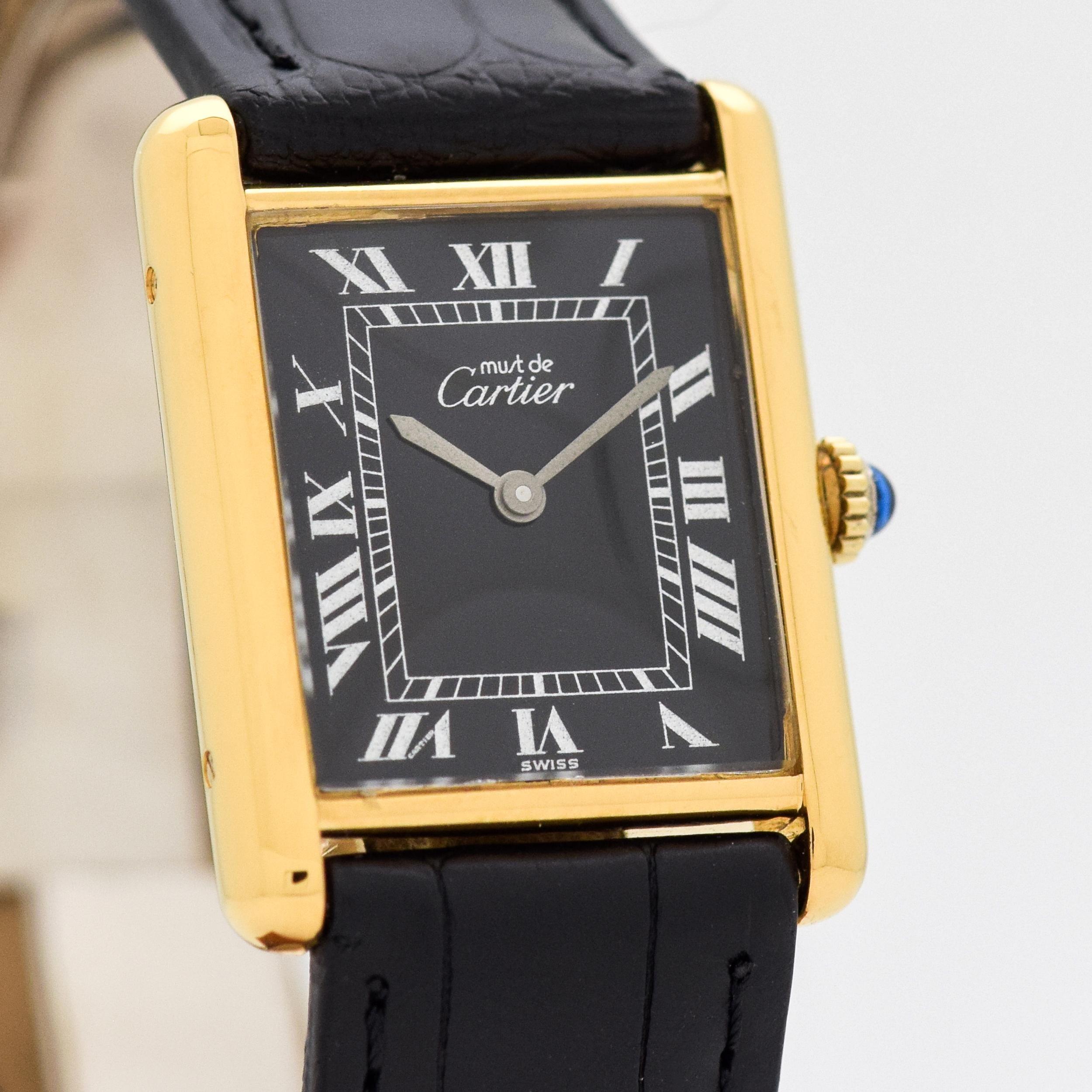 1990's Vintage Cartier Standard Men's Size Tank 18k Yellow Gold Plated Over Sterling Manual Wind watch with Original Black Dial with Silver Roman Numerals. Triple Signed. 23mm x 30mm lug to lug (0.91 in. x 1.18 in.) 17 jewel, manual-wind ETA