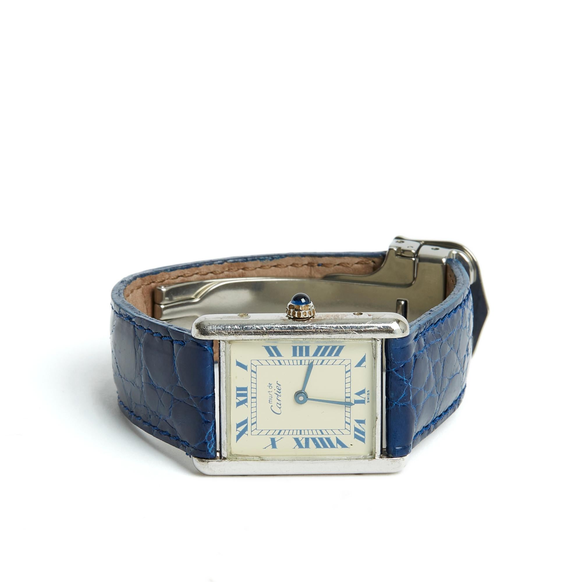 Cartier Must model Tank watch in 925/1000 silver, ecru background with blue railway indexes and Roman numerals, quartz movement, blue exotic leather strap, Cartier folding clasp in steel. Case width 23 mm (excluding crown), bracelet for 15.5 cm