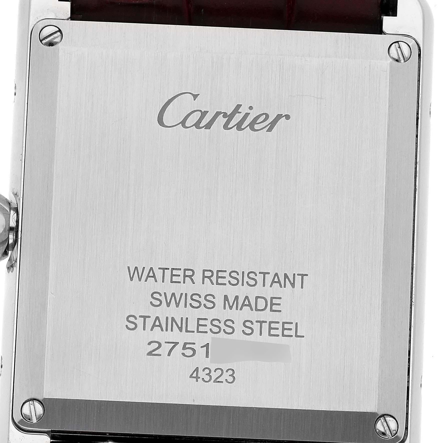 Cartier Tank Must Large Steel Red Dial Ladies Watch WSTA0054 Box Card. Quartz movement. Stainless steel case 33.7 x 25.5 mm. Circular grained crown set with blue spinel cabochon. . Scratch resistant sapphire crystal. Red dial with sword shaped steel